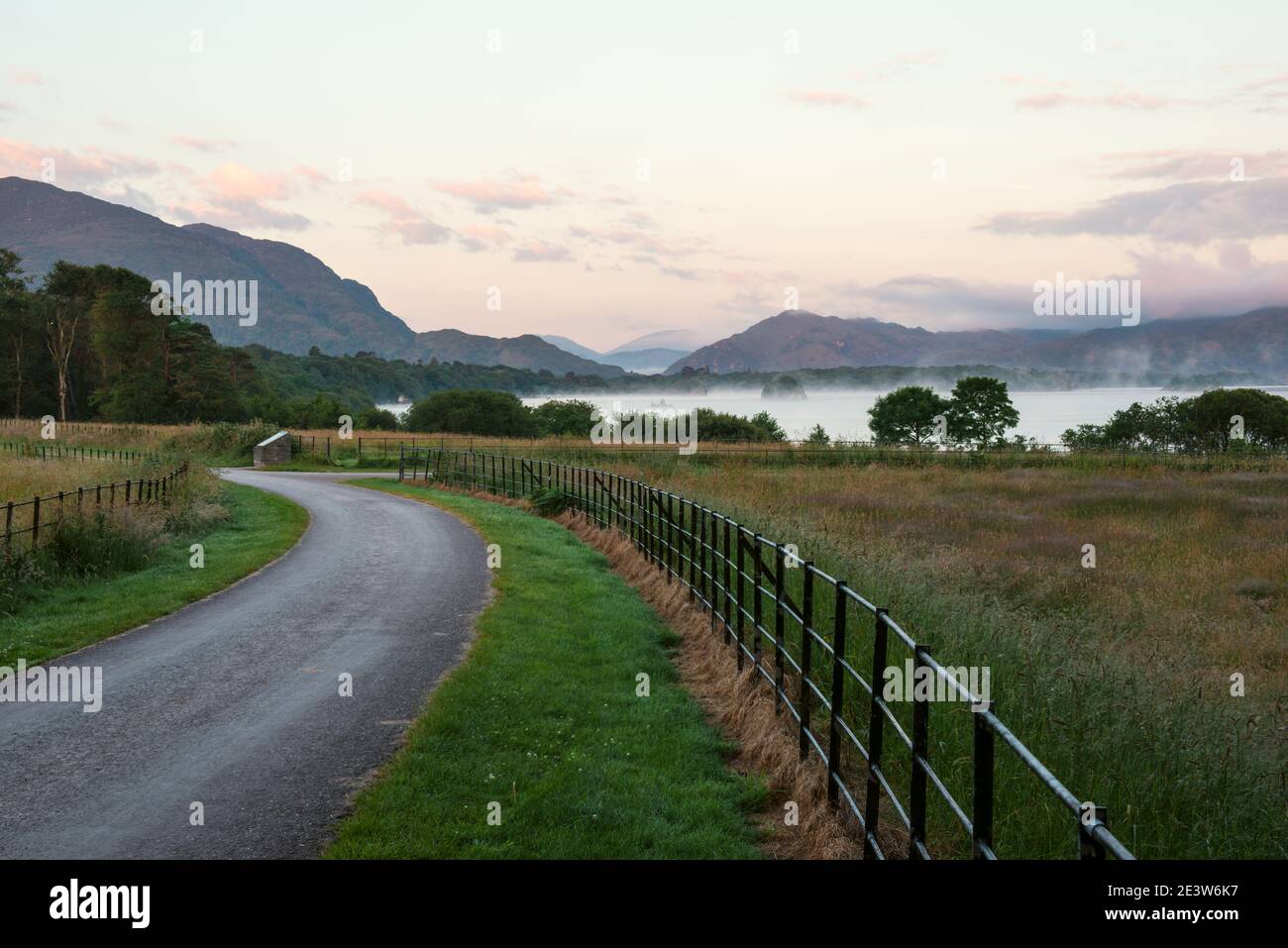 Killarney National Park countryside view of Torc Mountain at dawn at Castlelough Bay, Lough Leane Lake in fog. Irish landscape County Kerry, Ireland Stock Photo