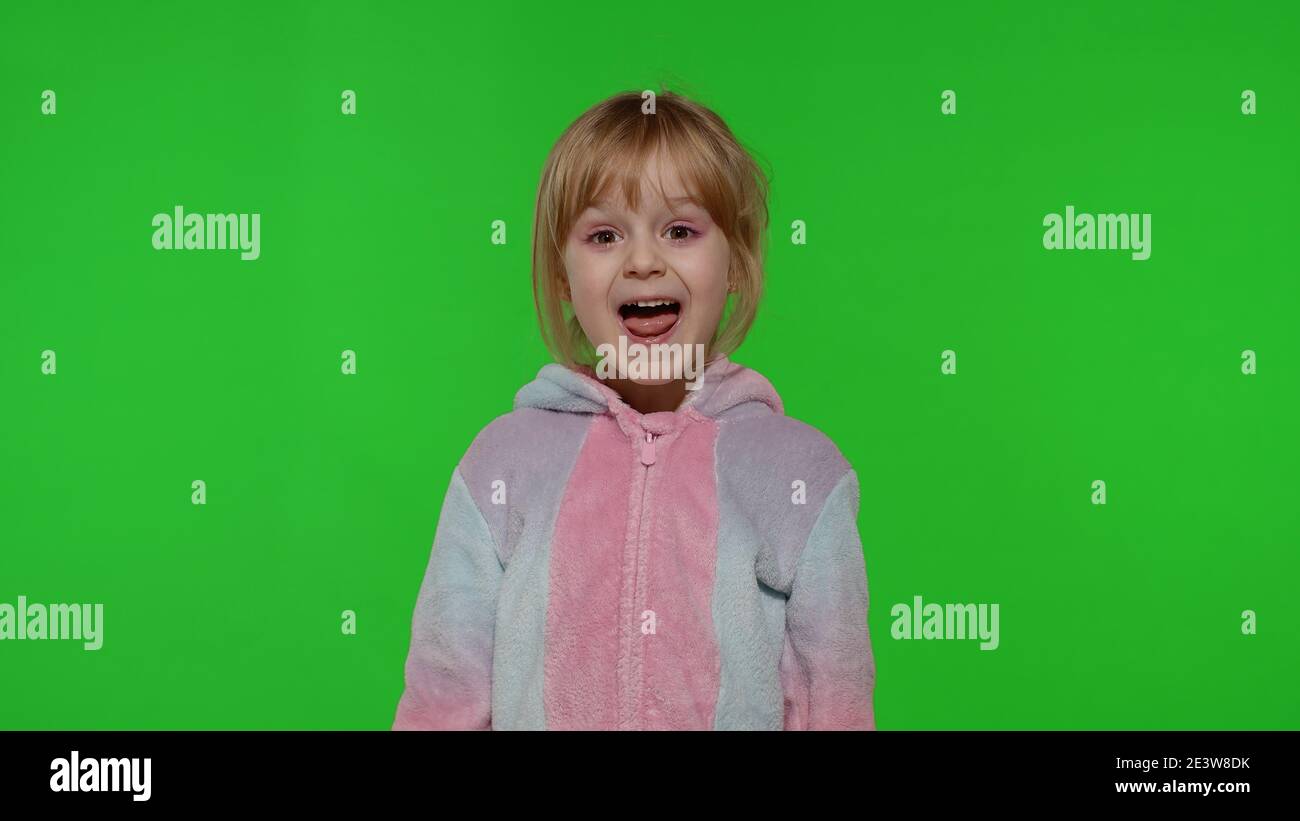 Child making silly funny faces, fooling around, showing tongue. Little