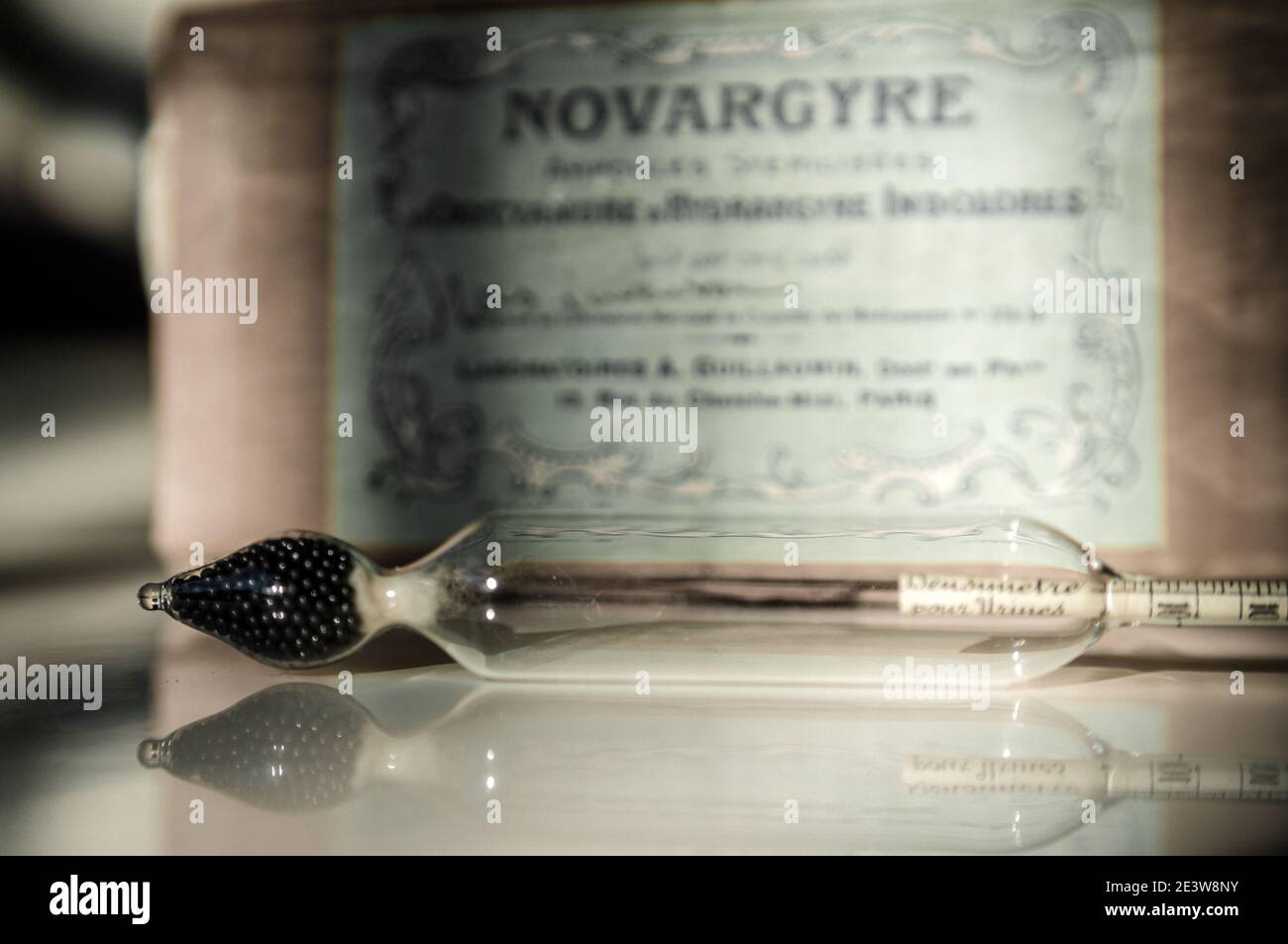 closeup of an ancient pharmaceutical ampoule in front of an old