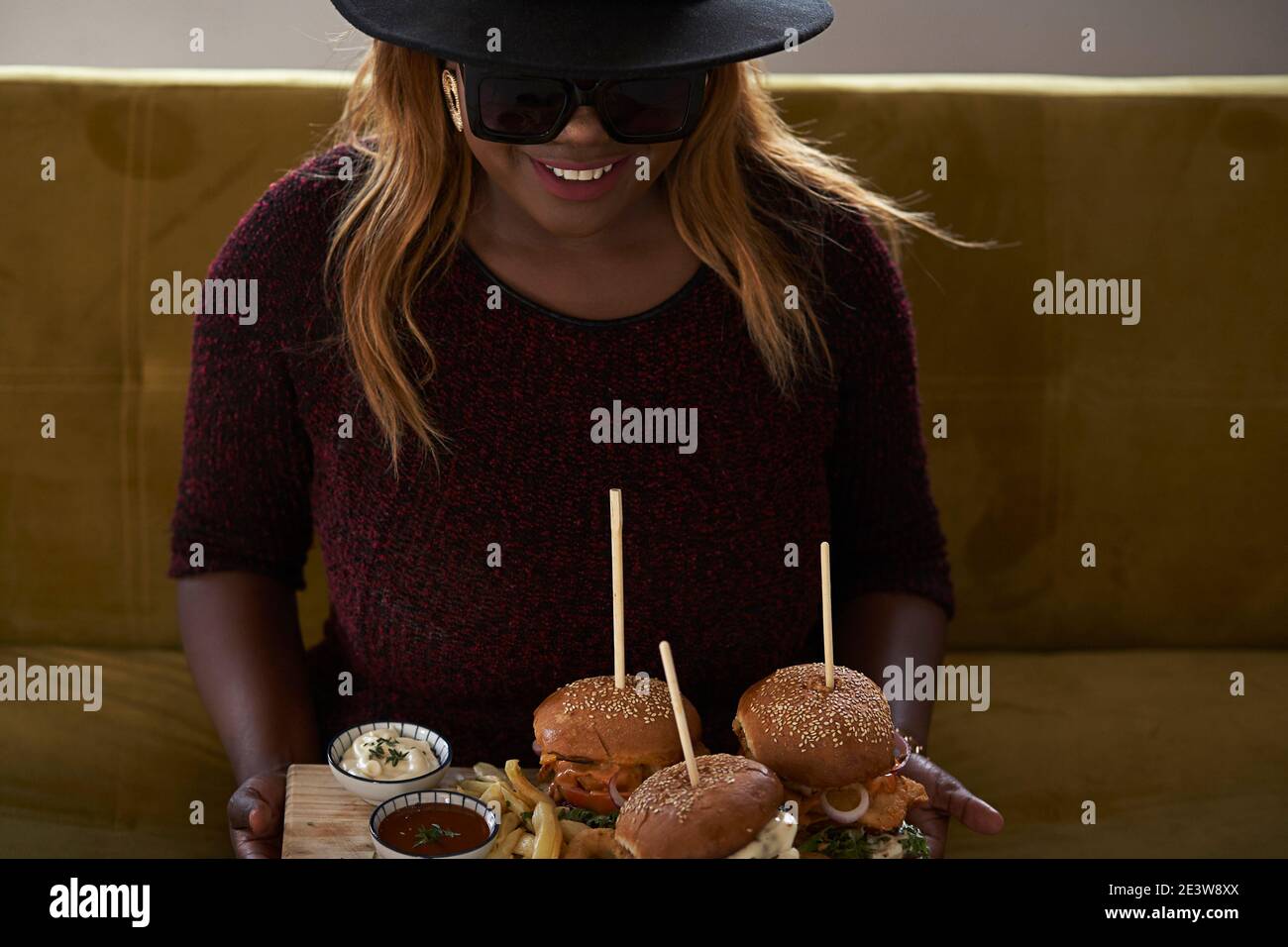 Faith Ngwenya, The hat and shades chef and owner of the Deluxe Burger Joint. Stock Photo