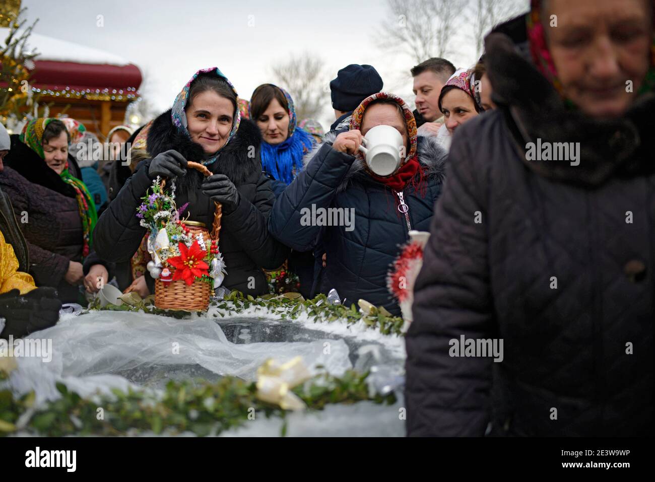 Non Exclusive: YAVORIV, UKRAINE - JANUARY 19, 2021 - Devotees get holy water during the Epiphany liturgy, Yavoriv village, Ivano-Frankivsk Region, wes Stock Photo