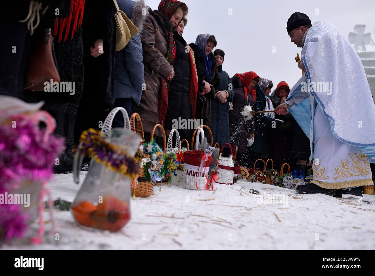 Non Exclusive: YAVORIV, UKRAINE - JANUARY 19, 2021 - A priest blesses the basket with the bottles of water during the Epiphany liturgy, Yavoriv villag Stock Photo