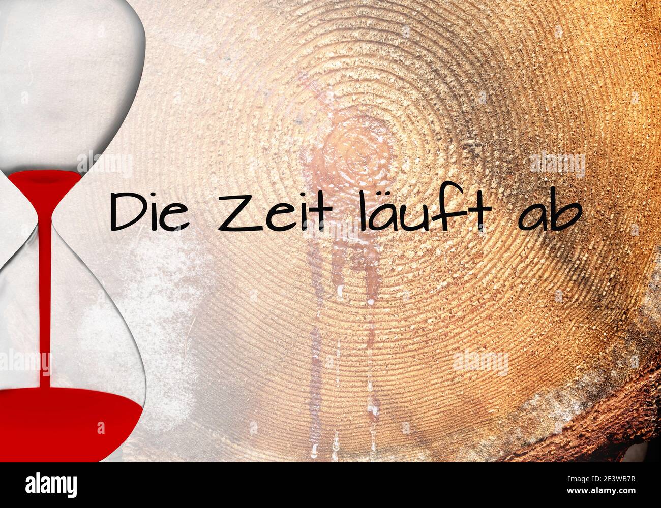 Egg timer with text: Die Zeit läuft ab -Time runs out on wooden background. Stock Photo