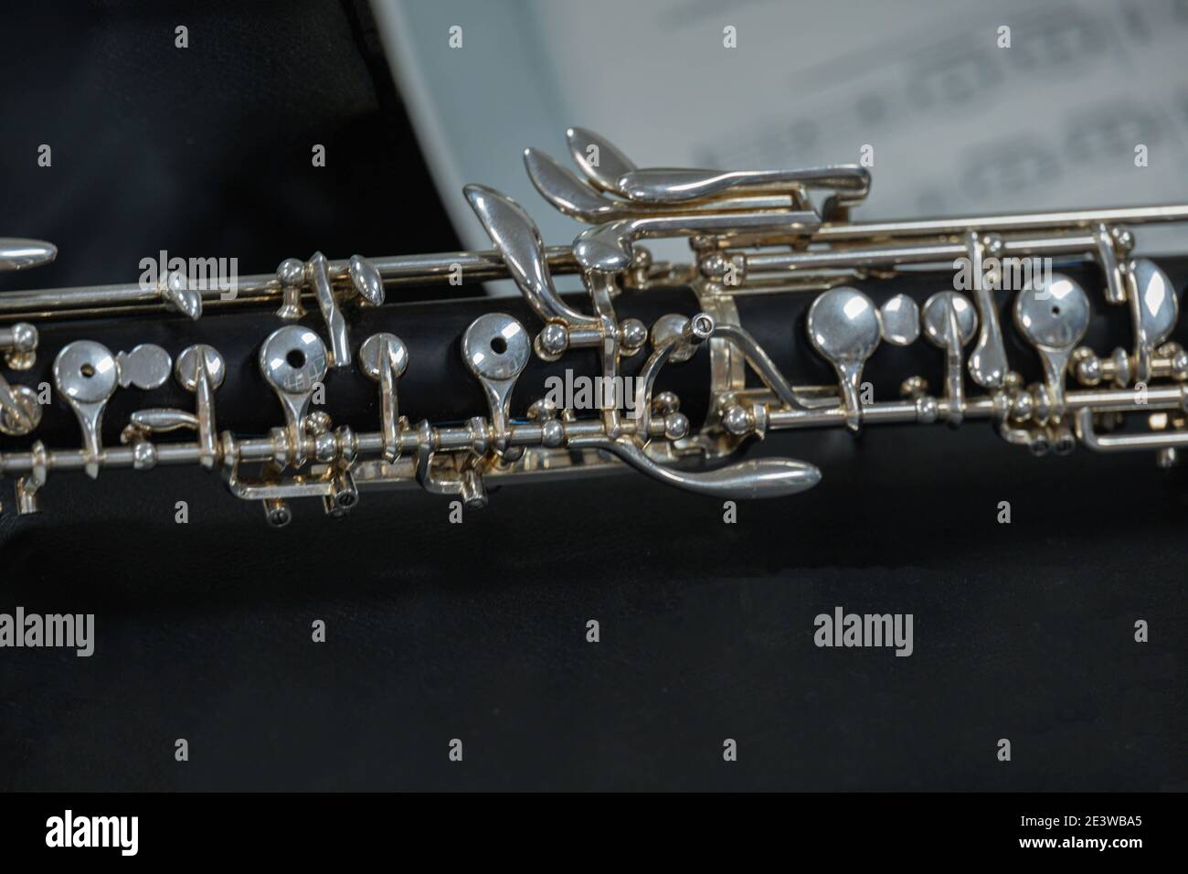 Oboe musical instrument resting on a score The oboe has a black body