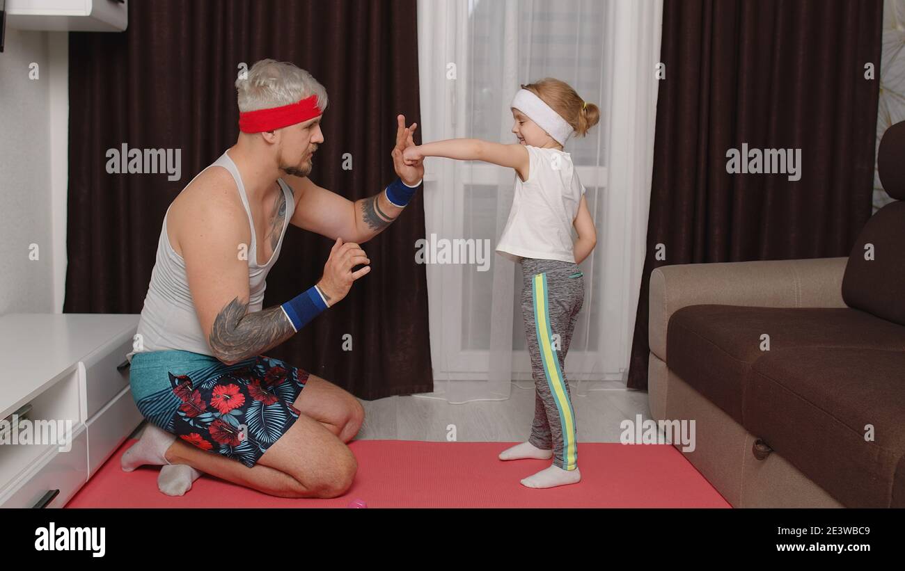 Retro style athletic man coach working out with child kid girl