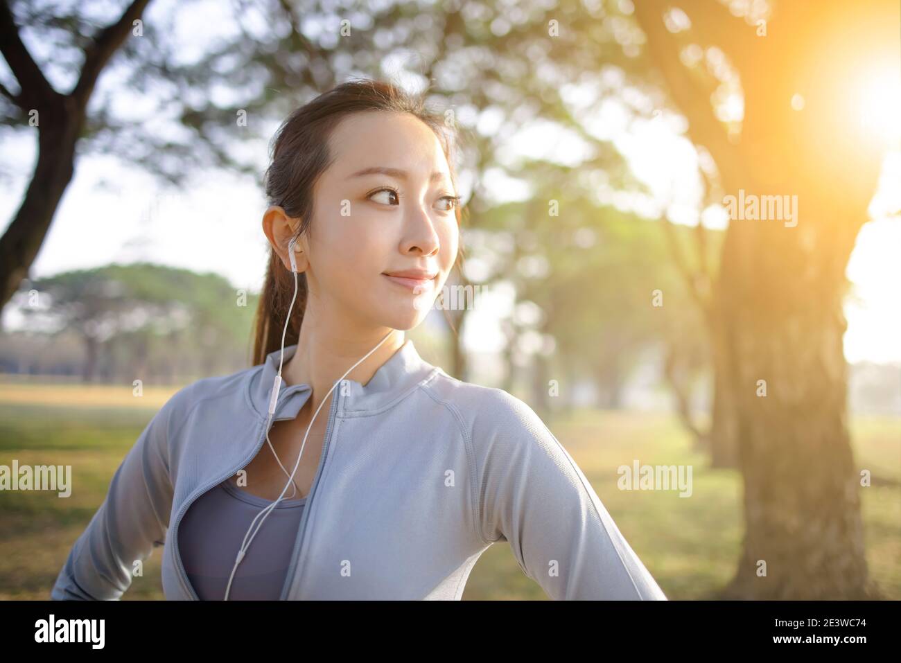 closeup beautiful young woman face before running in the park at  morning Stock Photo