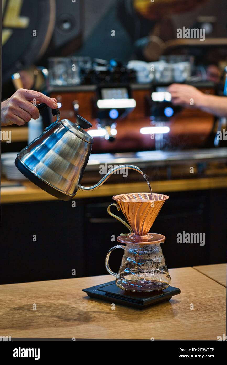 Barista pouring water into coffee on scale Bremen,Germany. Stock Photo