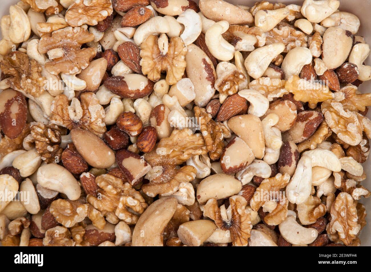 Selection of mixed nuts including Wall nuts Brazil nuts Cashew nuts Hazel nuts and Almond nuts. Daily intake of mixed nuts is good for healthy living Stock Photo