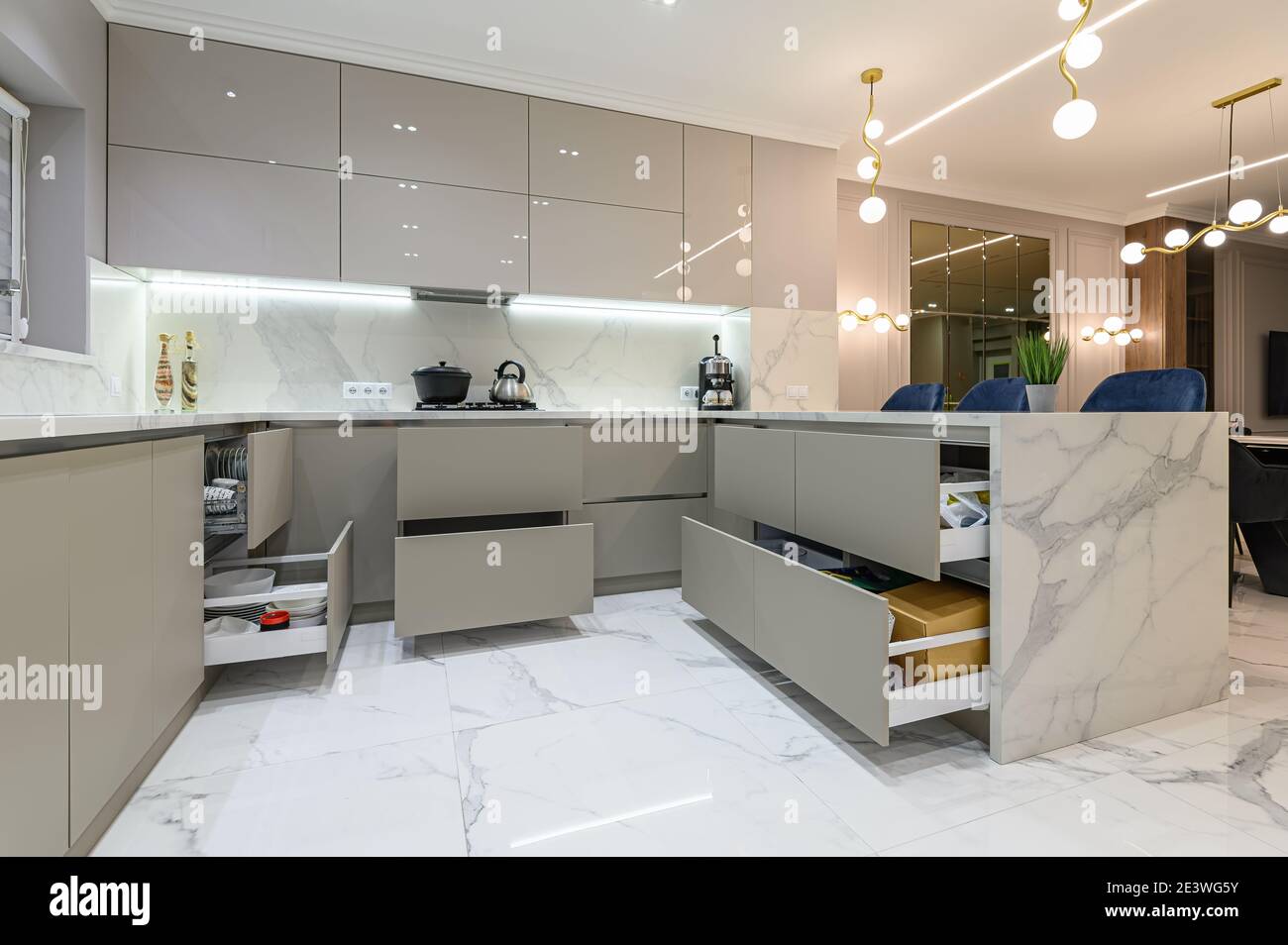 Open drawers at modern white kitchen furniture Stock Photo Alamy