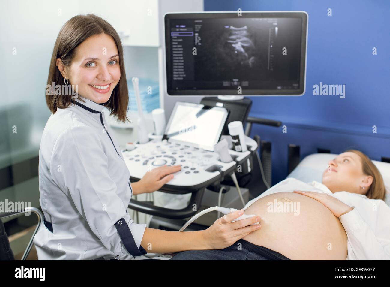 Close Up Portrait Of Cheerful Professional Woman Obstetrician Conducting Ultrasound Scan For 