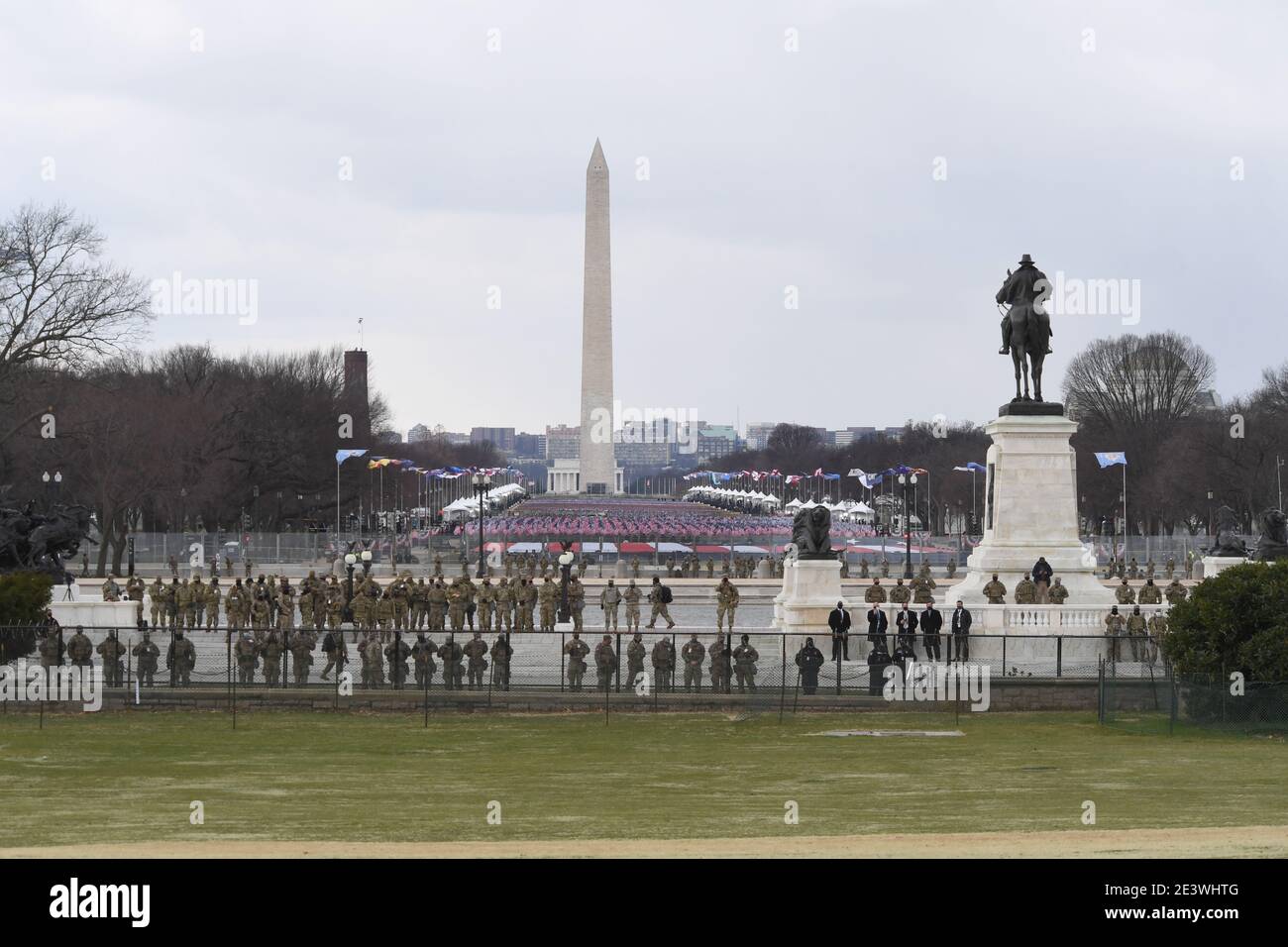 Washington, DC, USA. 20th Jan, 2021. 1/20/20- U.S. Capitol- Washington DC.The U.S.Capitol hosts the Inauguration of the 46th President of The United States Joseph R. Biden. National Guard Troops patrol outside the Capitol in front of the Field of 191,500 Flags and 56 Pillars of Light representing the Victims who died from Covid 19 Virus and Pillars of Light represent 50 states and six Territories. Credit: Christy Bowe/ZUMA Wire/Alamy Live News Stock Photo