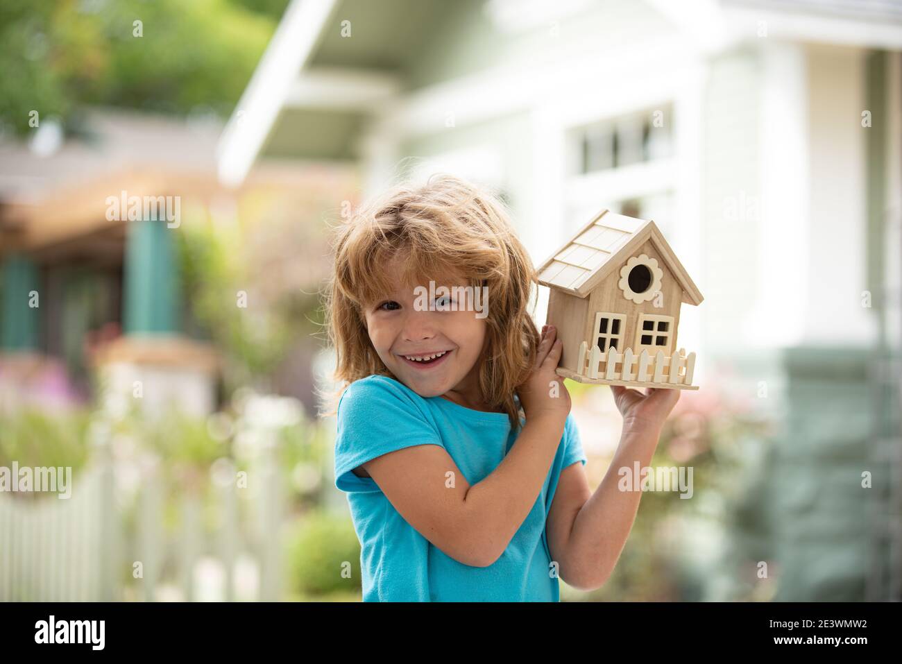 House in kids hands. Family home, home protecting insurance concept, Child boy building house, home care. Happy kid needlework concept. Diy project Stock Photo