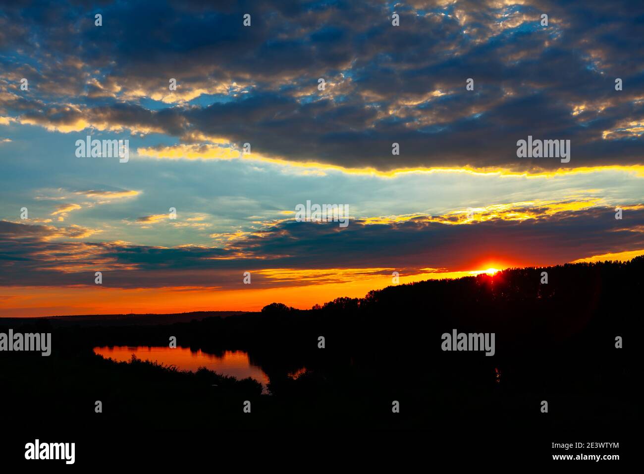 Scenery of the breathtaking sunset reflecting in the lake Stock Photo ...