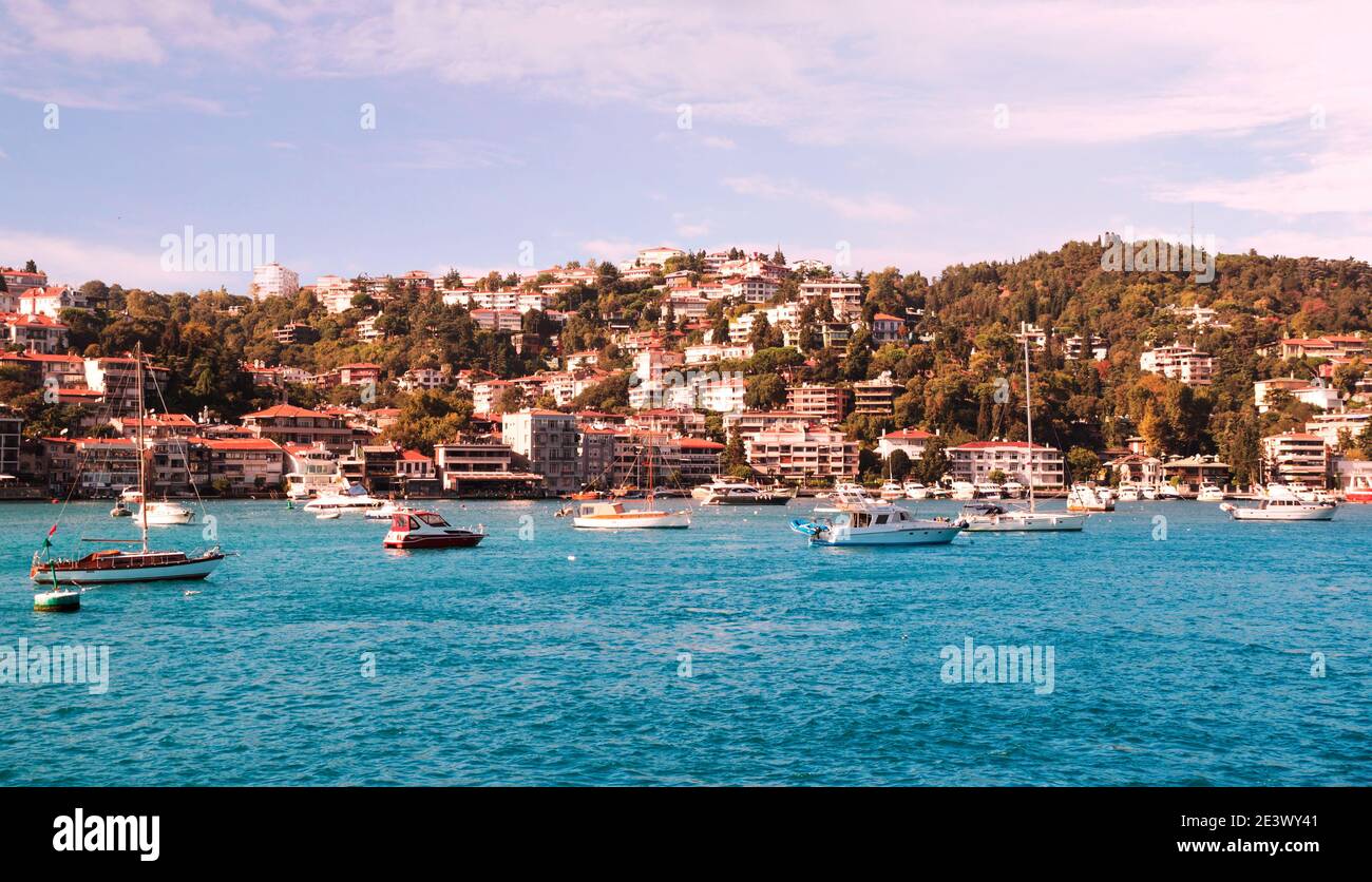 View on marine in Bosporus Strait with boats and ships before hilly residential blocks of Bebek neighborhood behind Cevdet Pasa street in Besiktas Stock Photo
