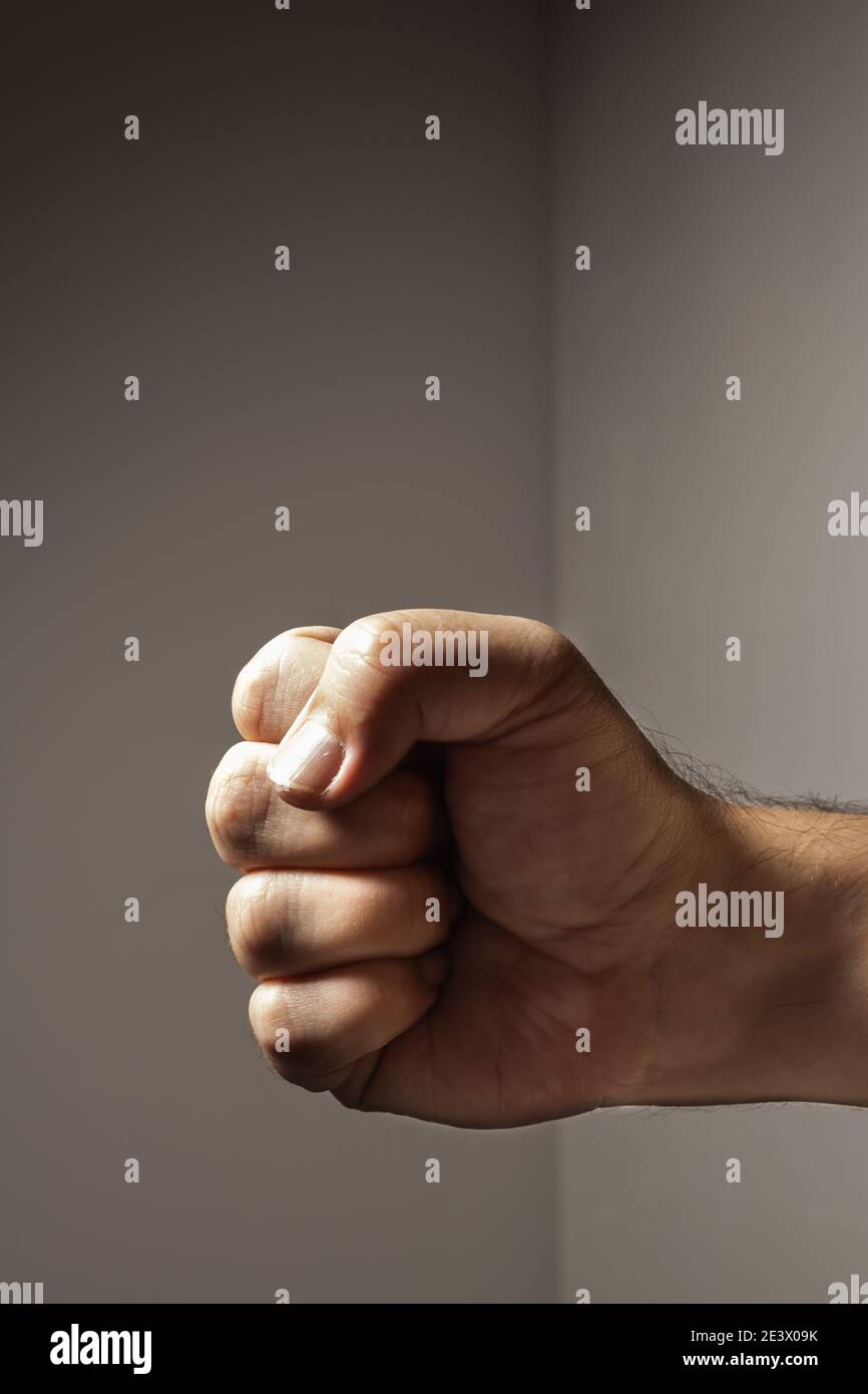 Clenched fist of a white male forward and sideways. Concepts of strength and anger. Stock Photo