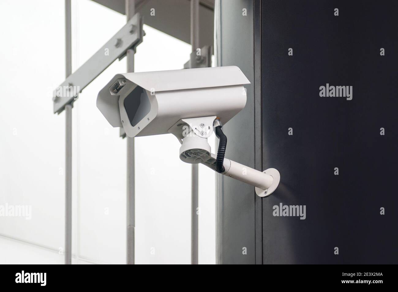 Security camera on black wall Stock Photo