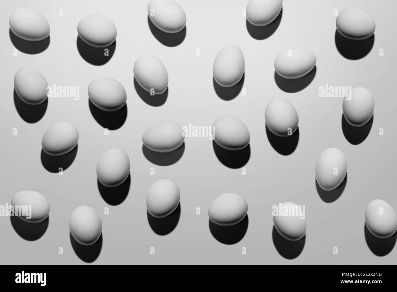 White eggs with shadow make pattern on white background Stock Photo