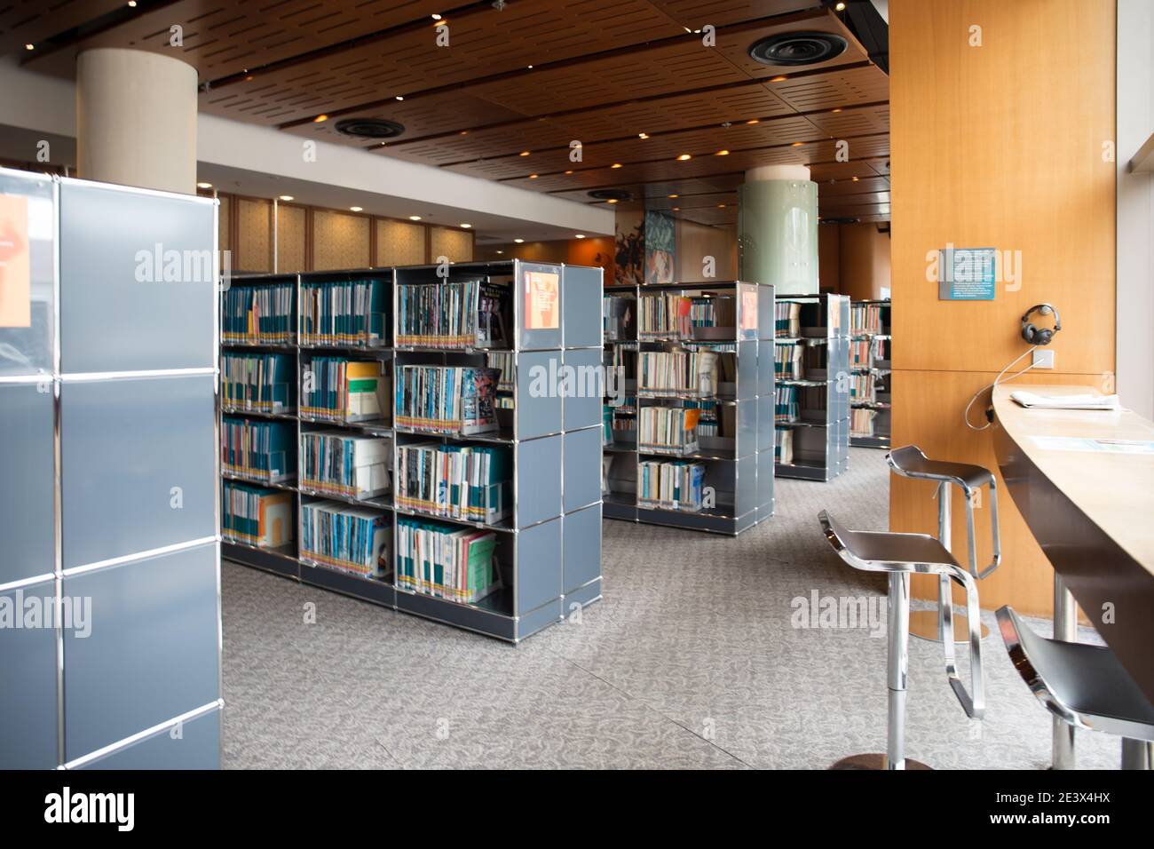 Modern public library interior with bookshelves and study bar seating Stock Photo