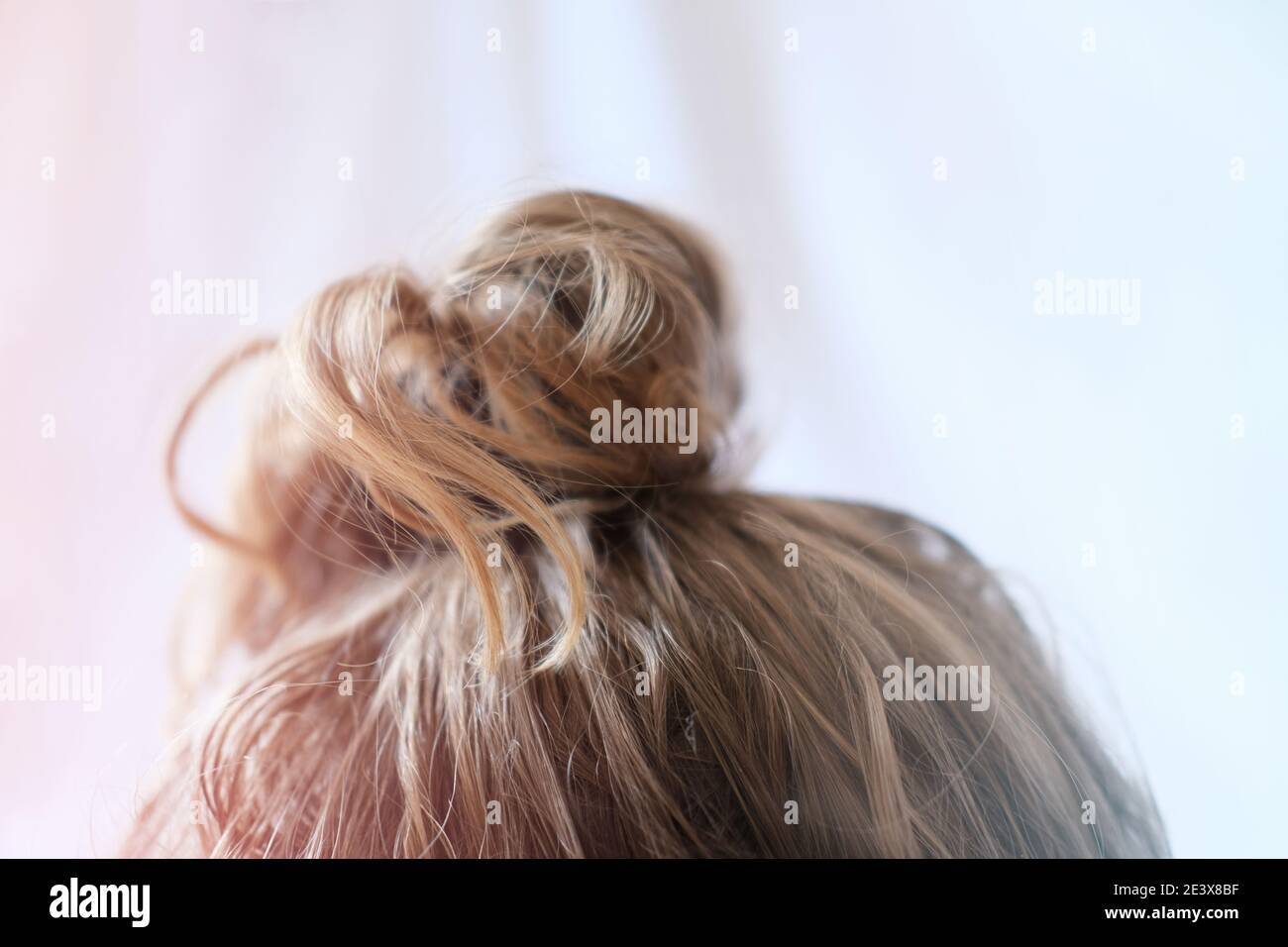 messy bun on the head of a blonde woman. quick hairdo at home because of  quarantine. Modern fast hairstyle messy hair. bad hair day concept Stock  Photo - Alamy