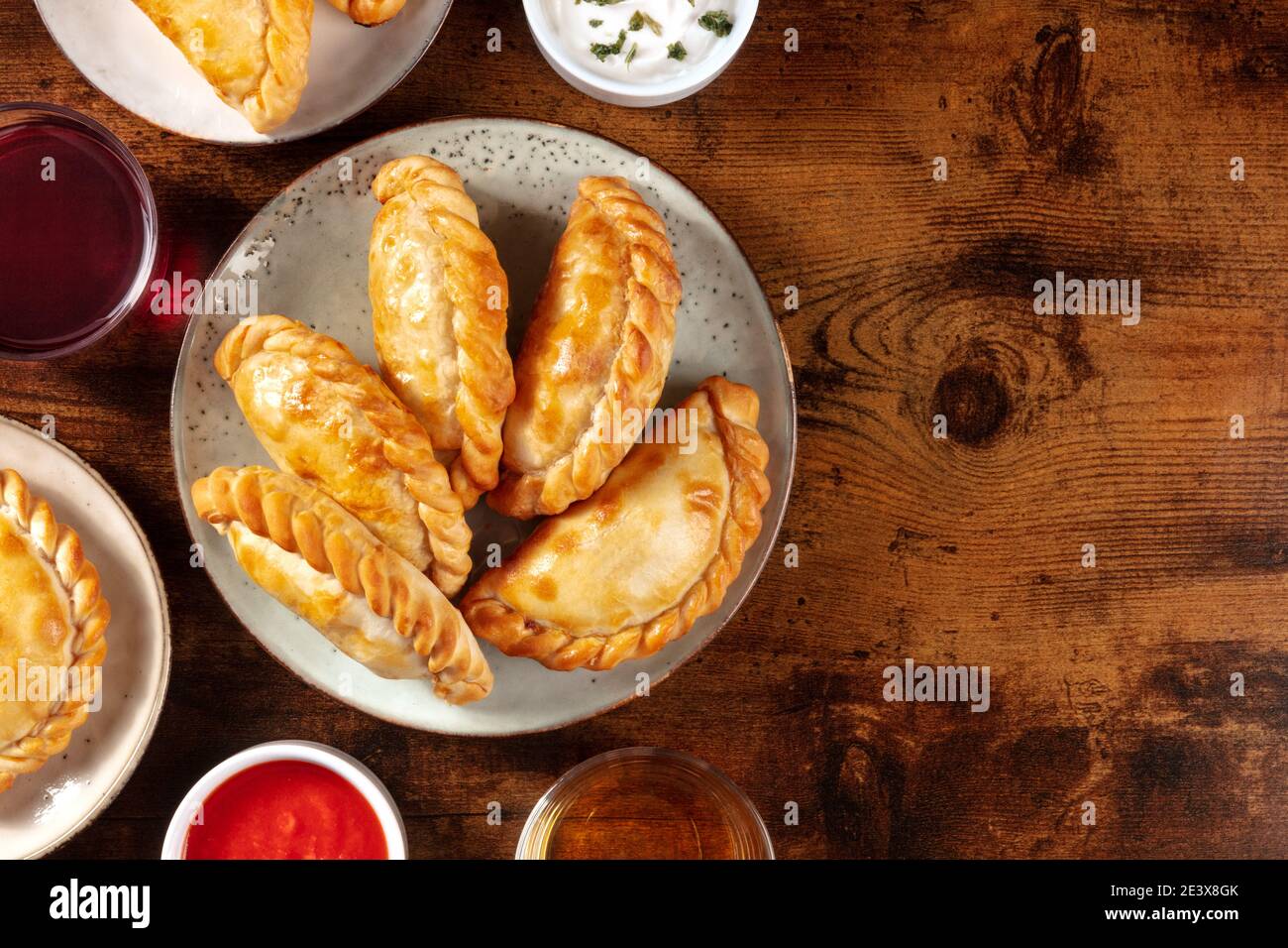 Empanadas dinner, shot from above on a dark rustic wooden background ...
