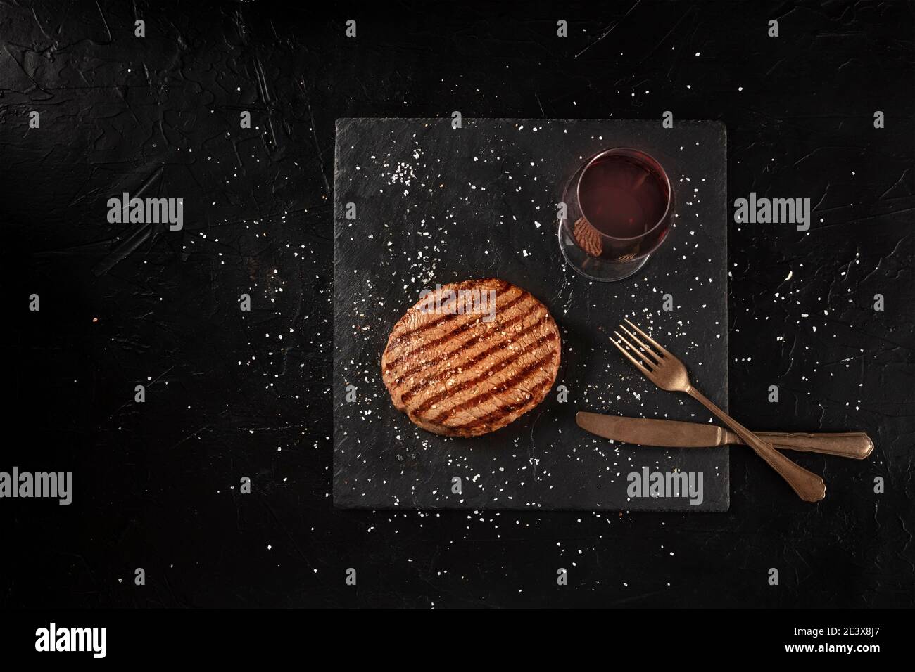 Grilled wagyu beef steak with red wine, shot from the top on a black