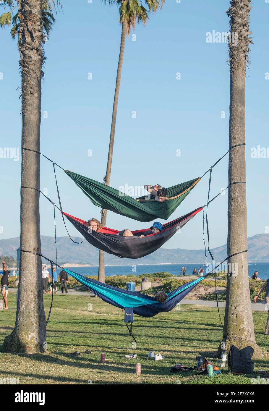 Santa Barbara, California, USA. 20th Jan, 2021. People relax in a tripledecker hammock strung