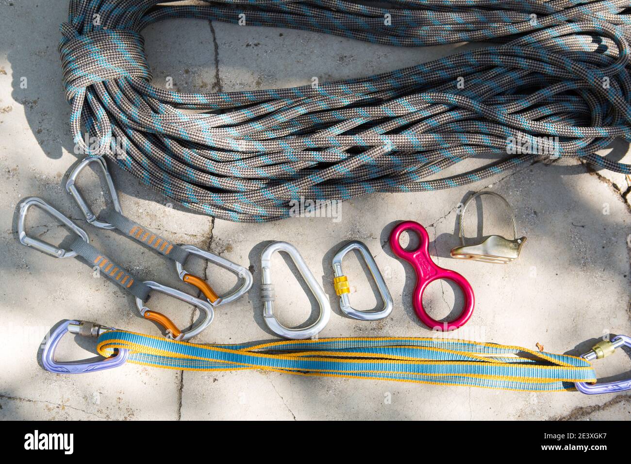 Coiled climbing rope and steel carabiner. Mountain climbing equipment
