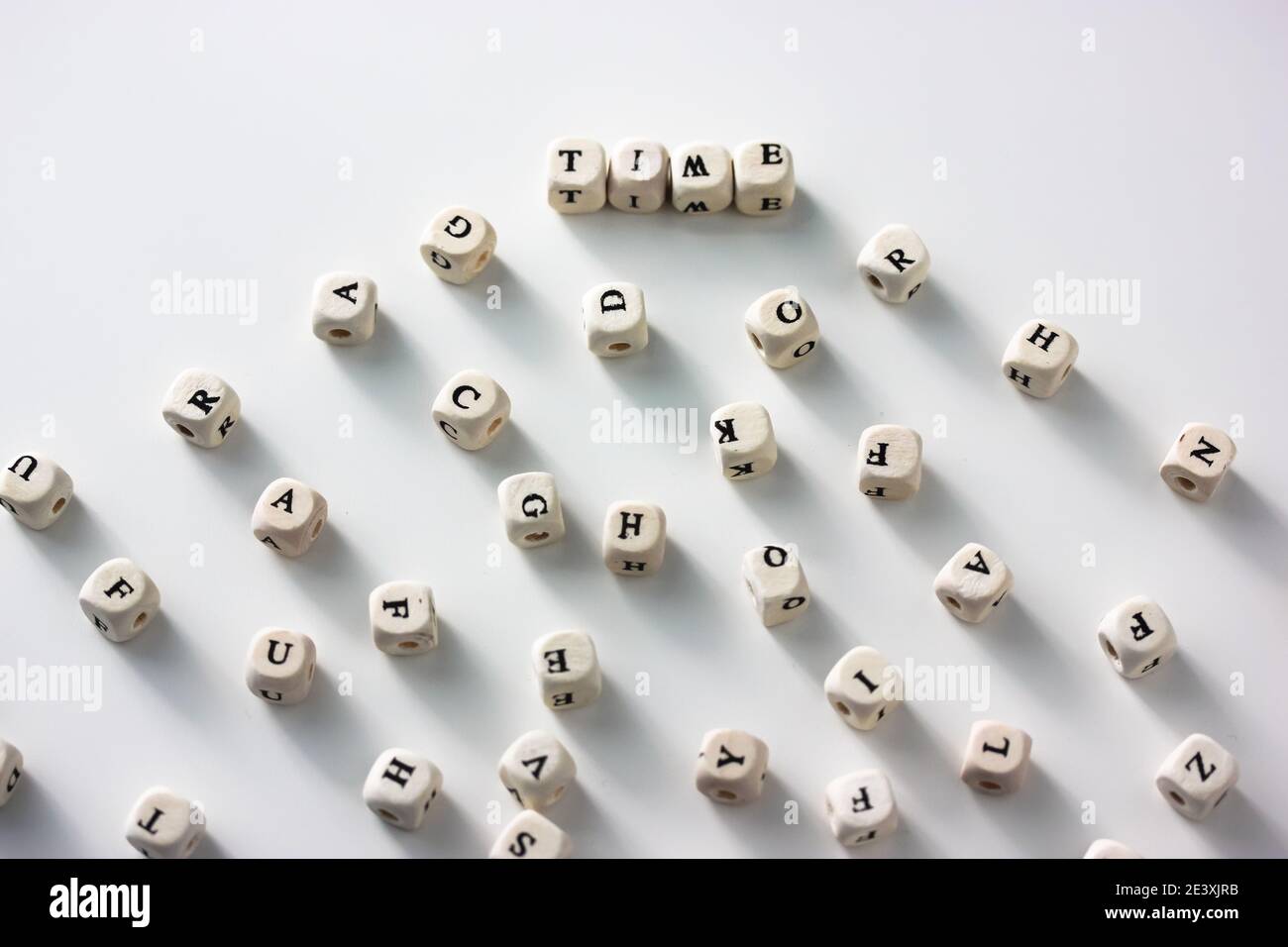 Time - the words written on wood blocks, white table, black and white ...