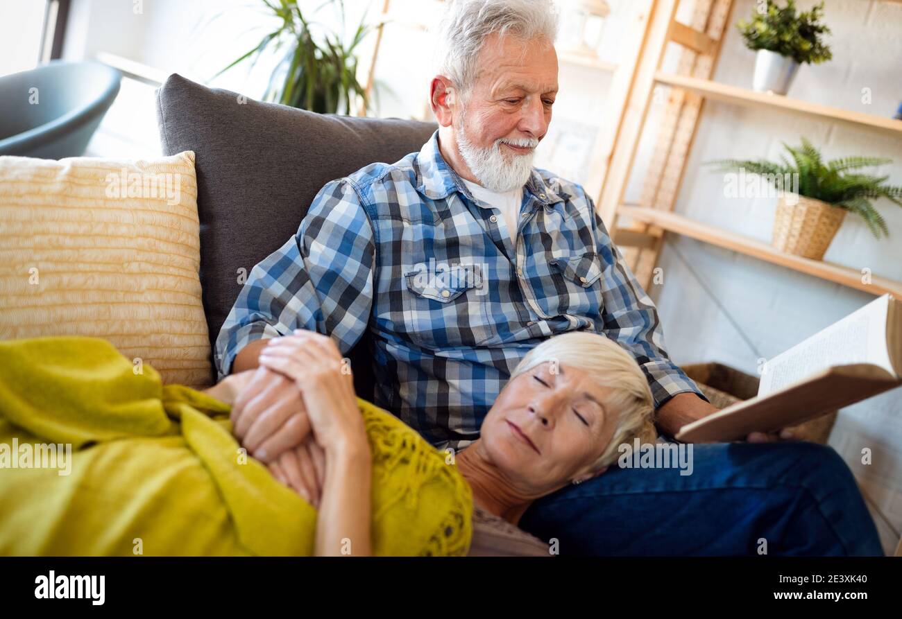 Happy senior couple relaxing at home together Stock Photo - Alamy
