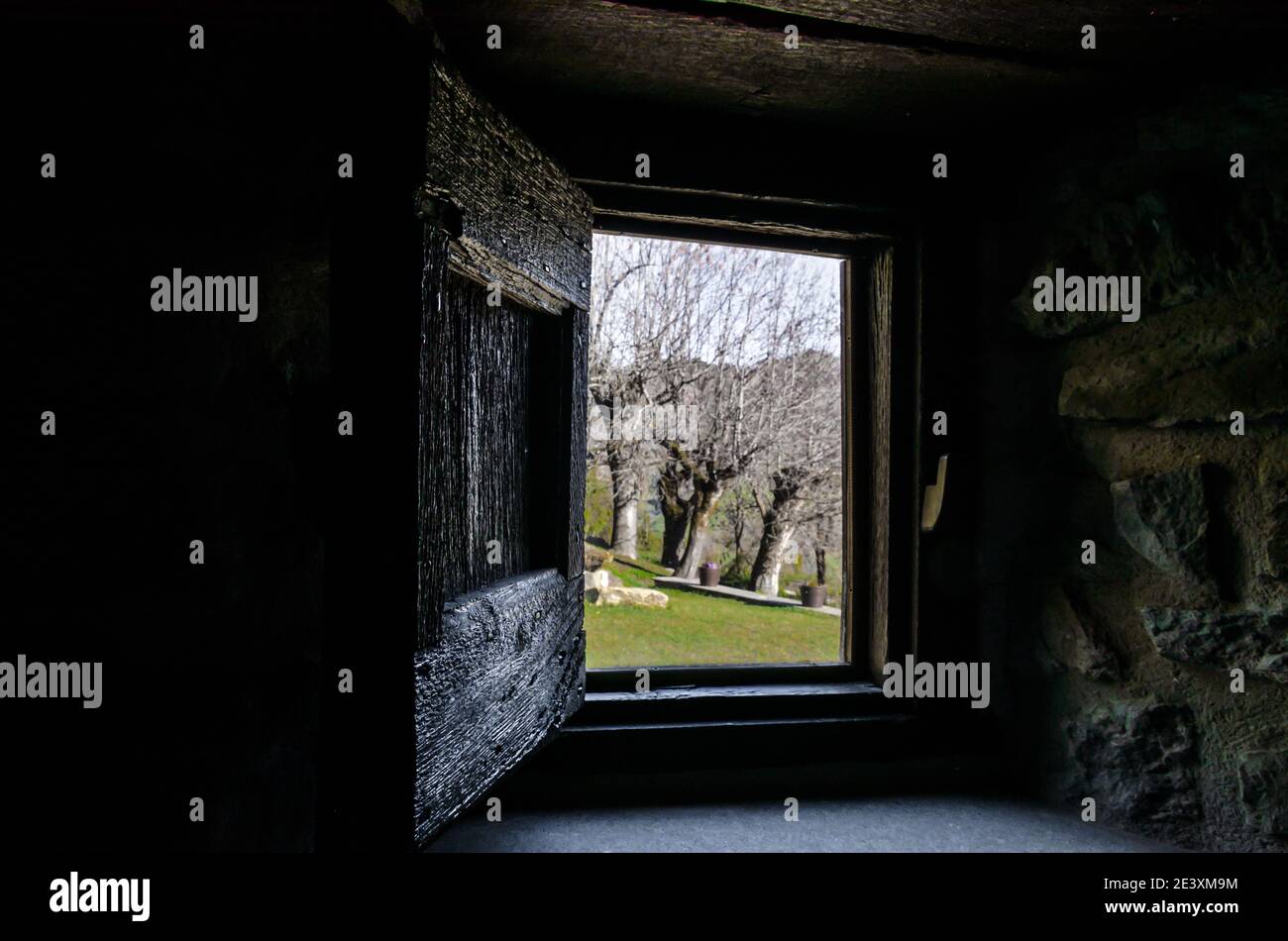 Interior view from the window of a rustic house towards a beautiful ...