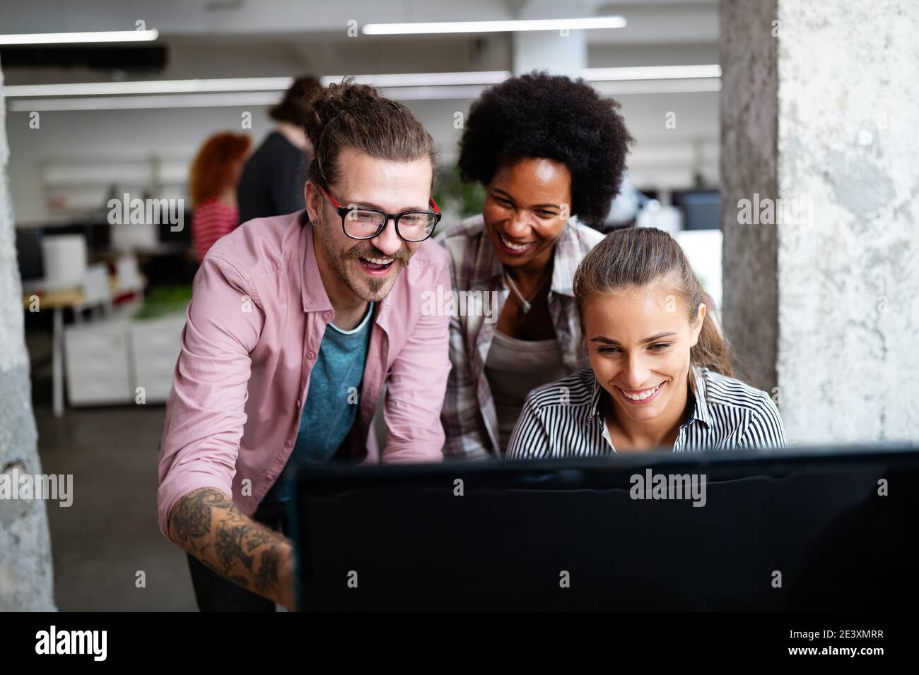 Programmers cooperating at IT company developing apps Stock Photo
