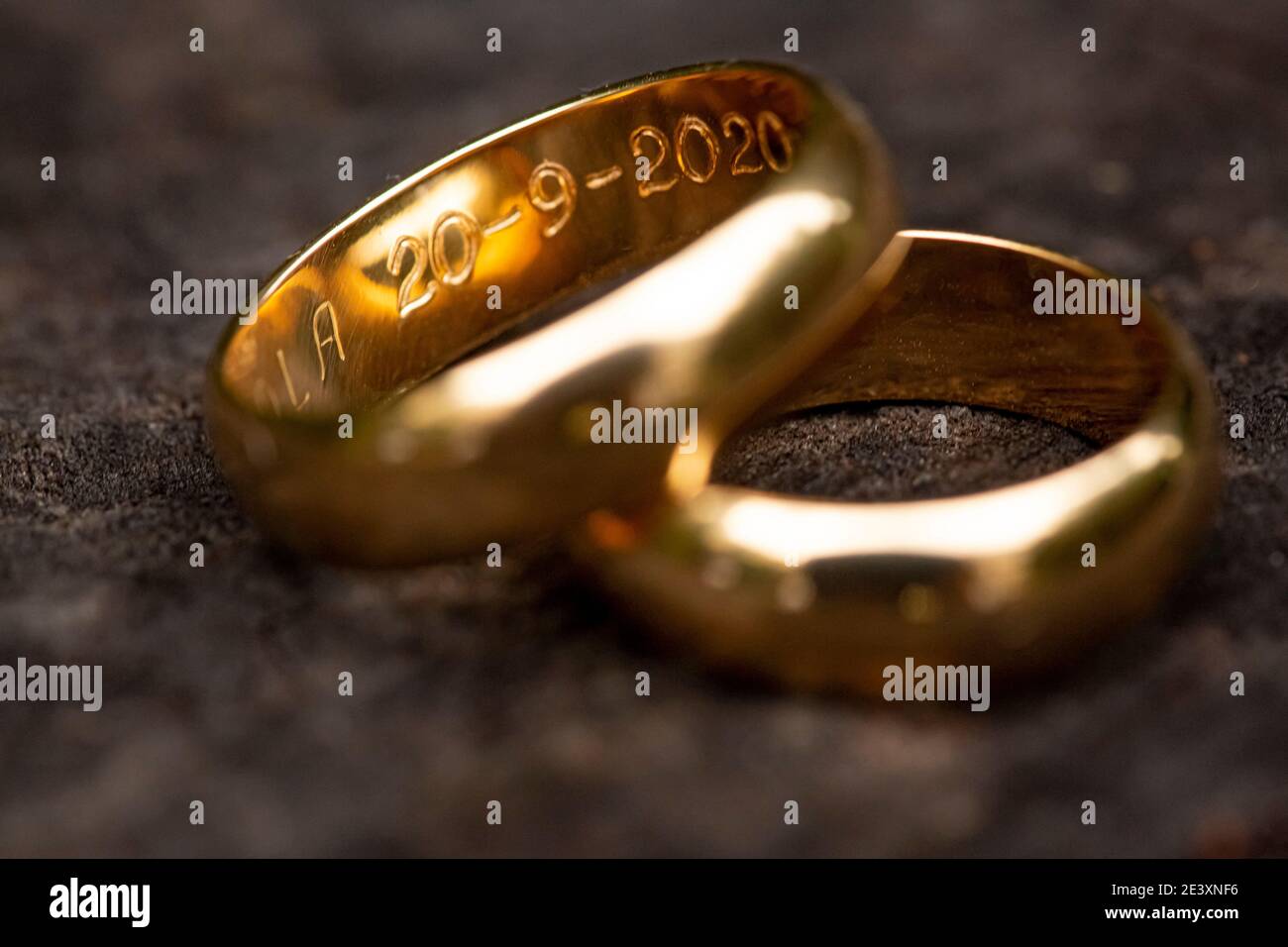 wedding rings with detail of the dates engraved in the ring Stock Photo Alamy