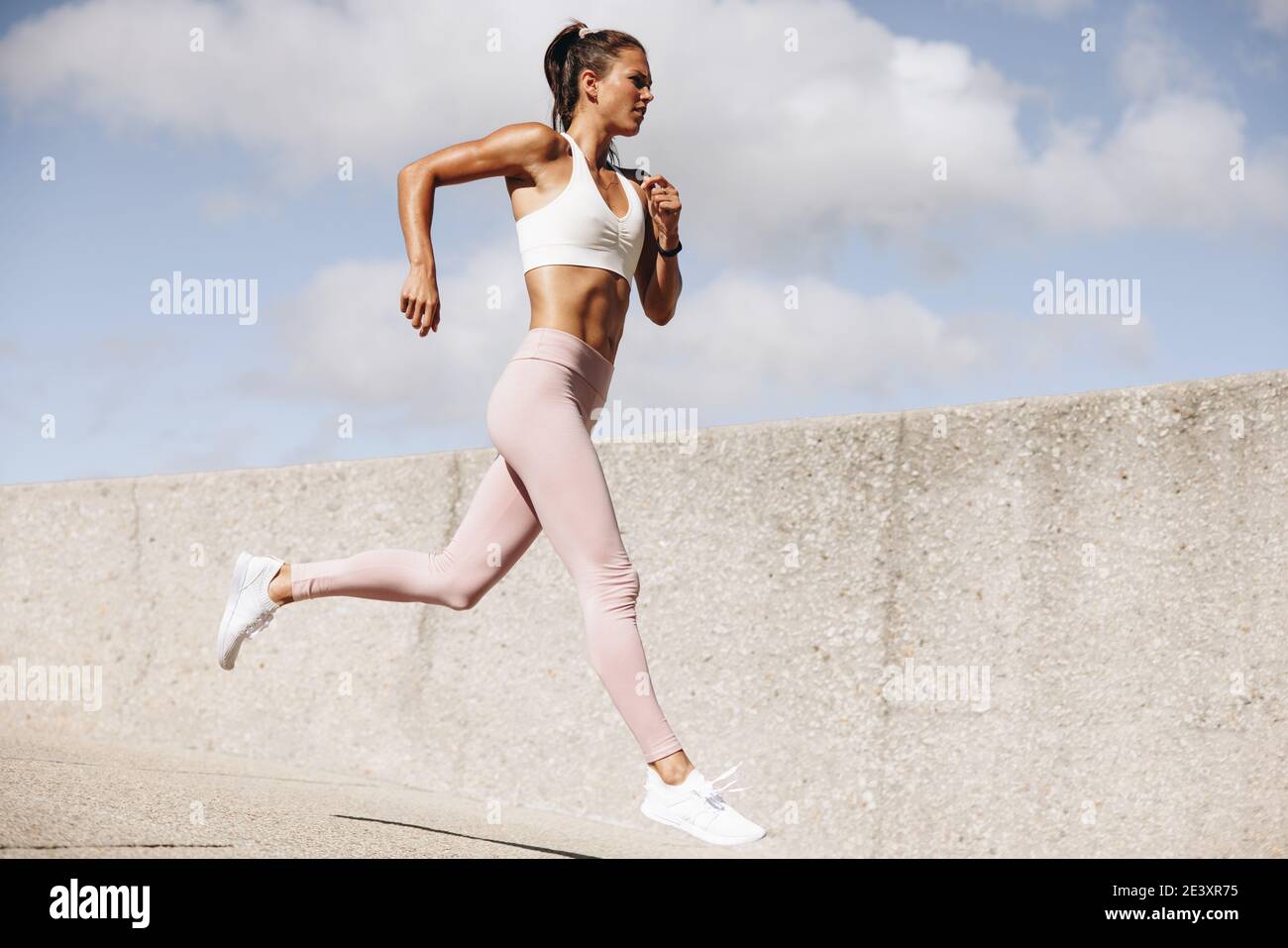 Sports woman running outdoors in the morning. Female athlete in