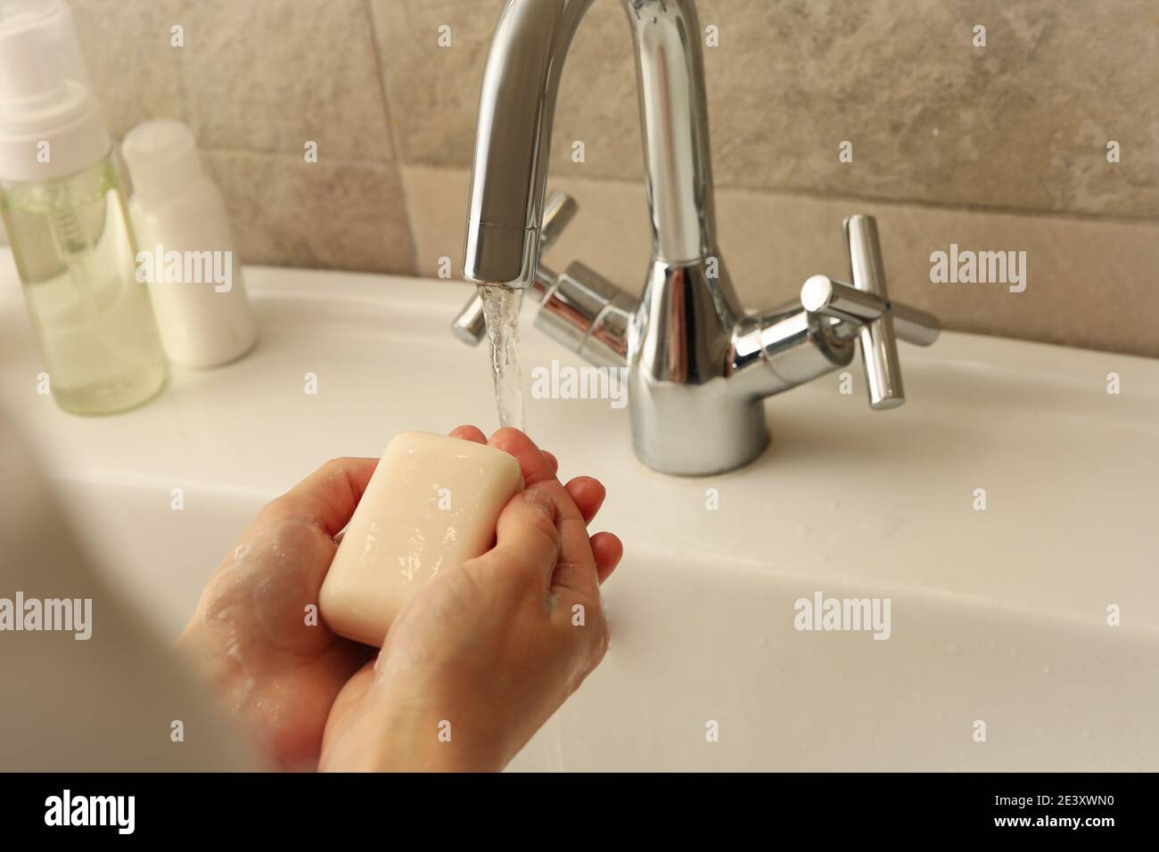 Woman washing hands in bathroom sink with soap Stock Photo - Alamy