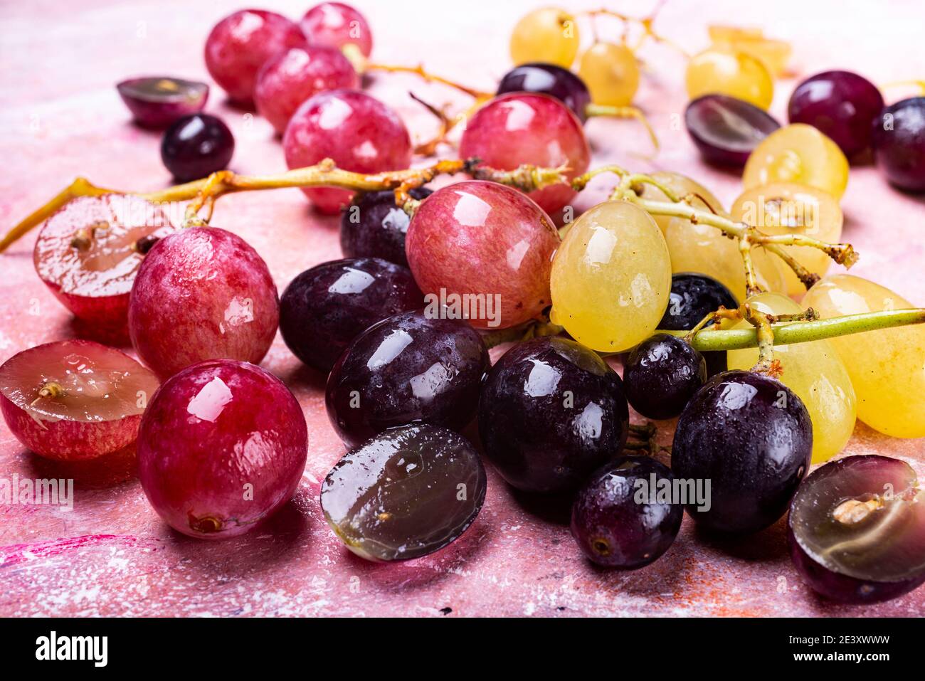 Fresh berries of table grapes of various types on a textured background