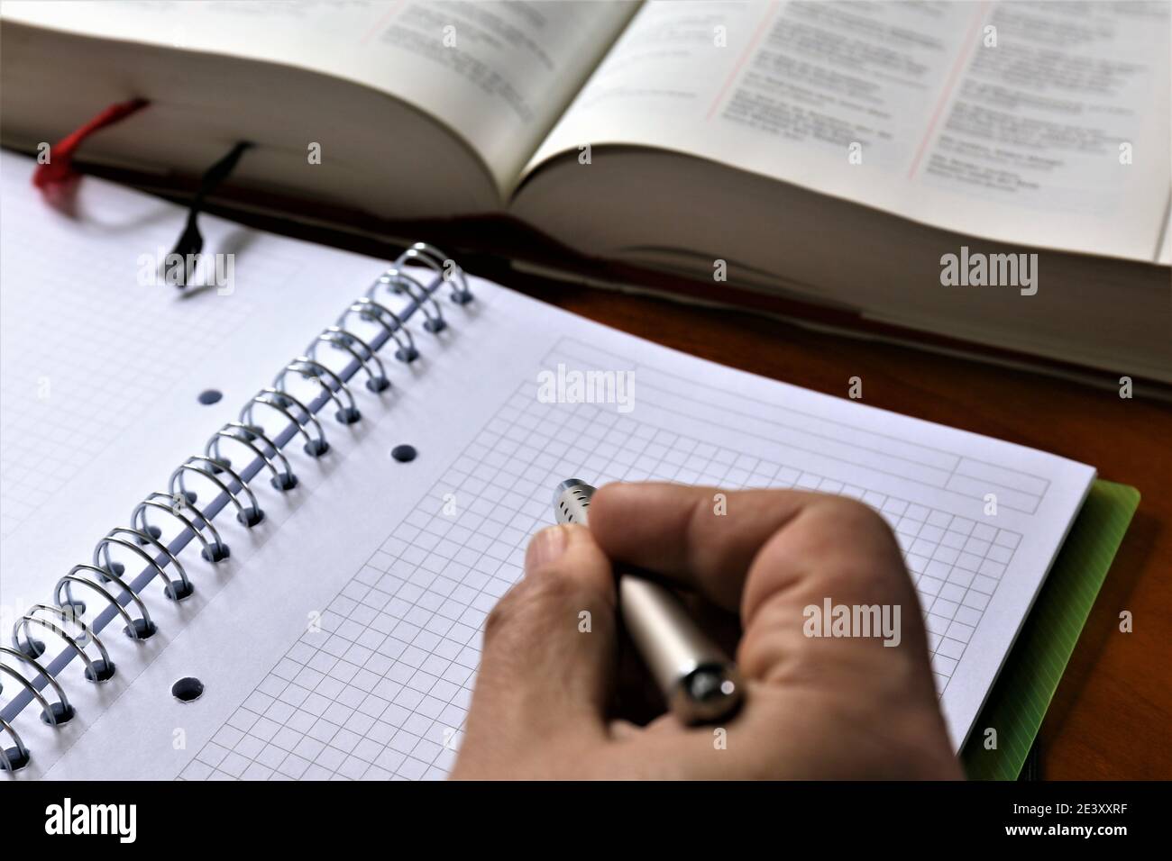 person writing on a notebook Stock Photo