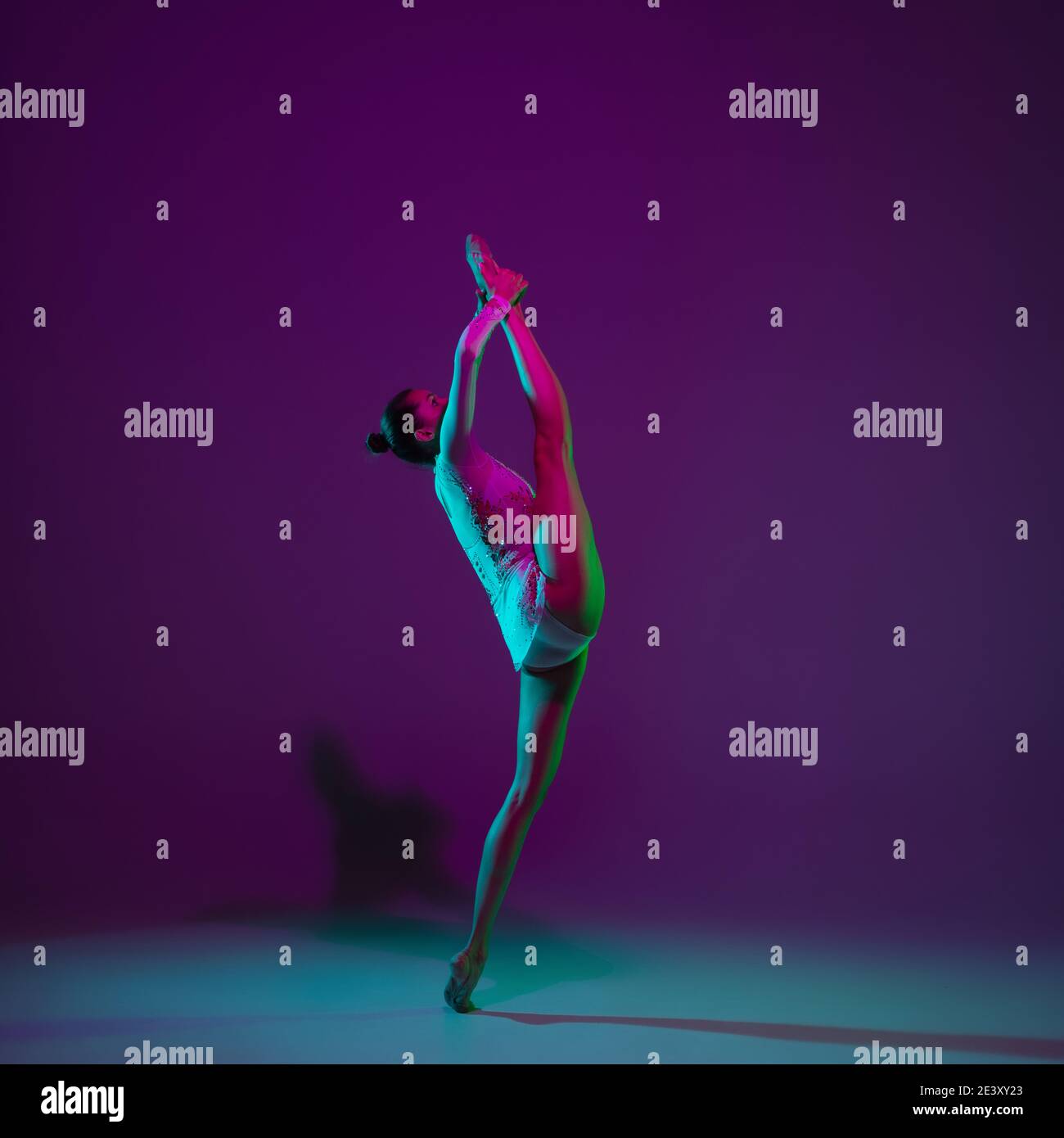 Motion. Young female athlete, rhythmic gymnastics artist dancing