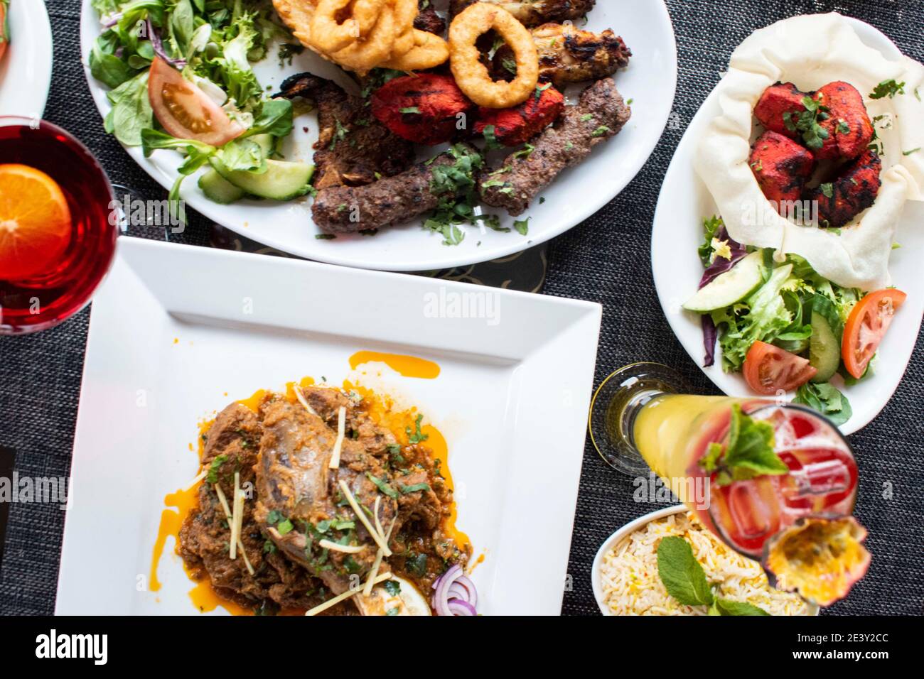 Indian cuisine food platter curry rice kebabs salad Stock Photo Alamy