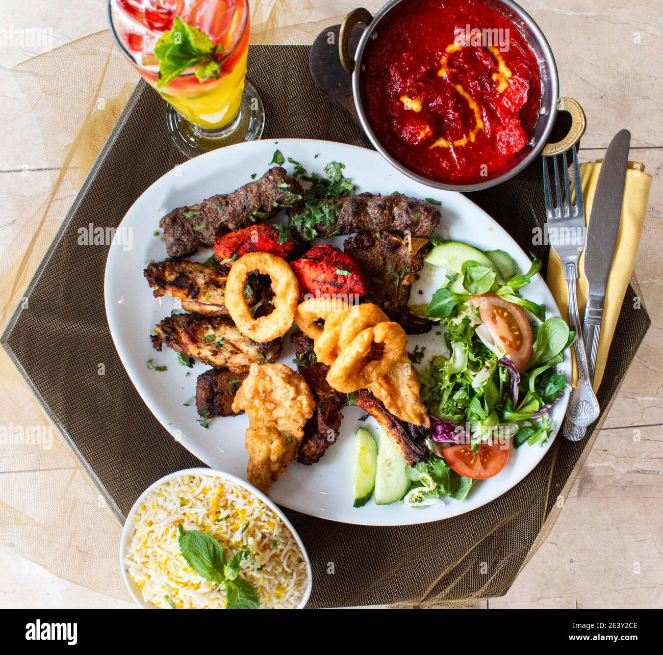 Indian cuisine food platter curry rice kebabs salad Stock Photo Alamy