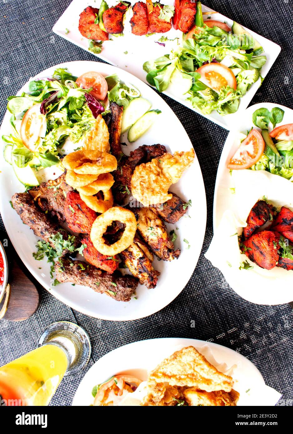 Indian cuisine food platter curry rice kebabs salad Stock Photo Alamy