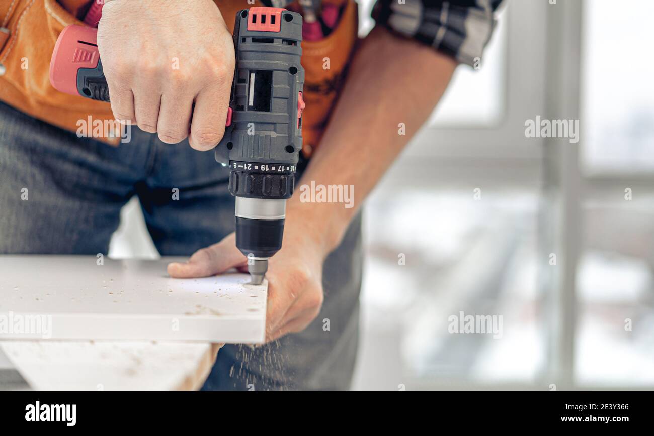 Man working during process of furniture manufacturing Stock Photo - Alamy