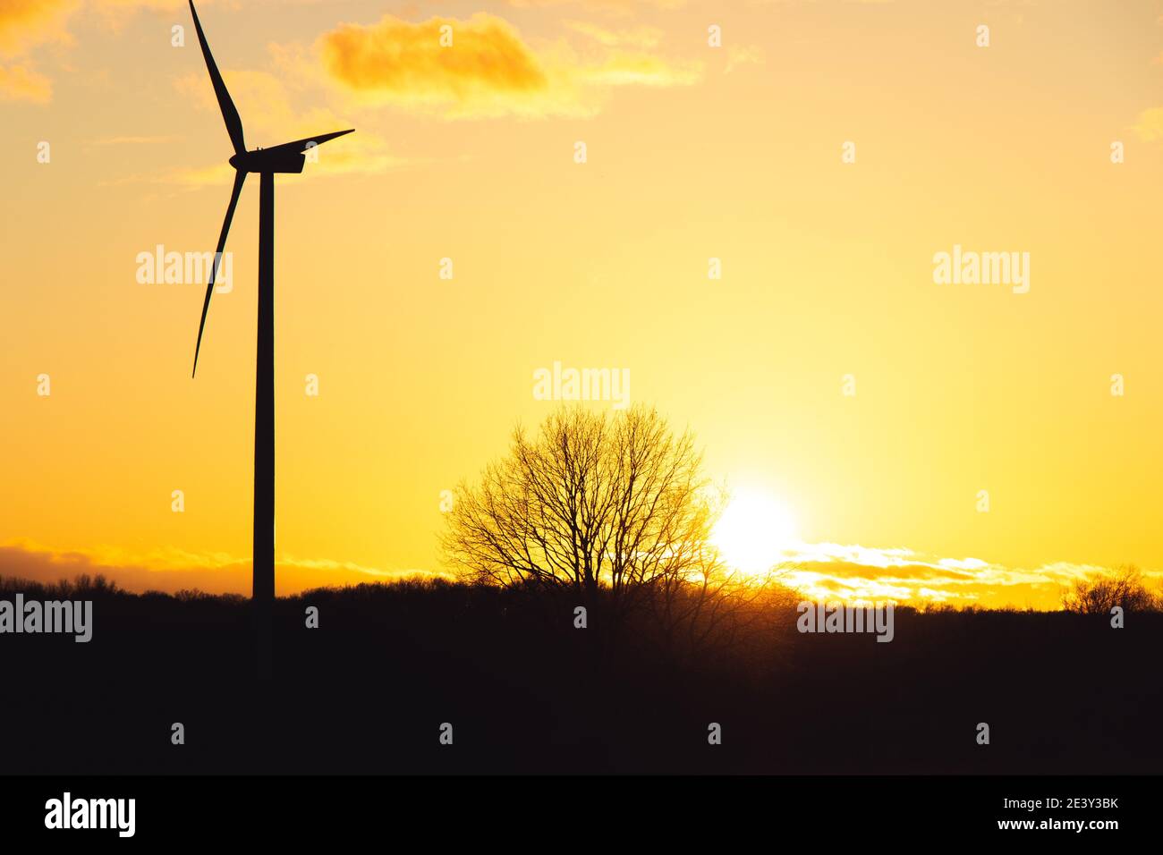 Black Silhouette of windturbines energy generator on amazing sunset at a wind farm in langenberg, germany Stock Photo