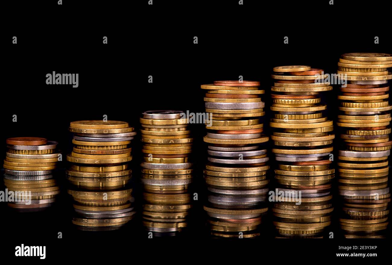 Composition of the coins on the black background Stock Photo - Alamy
