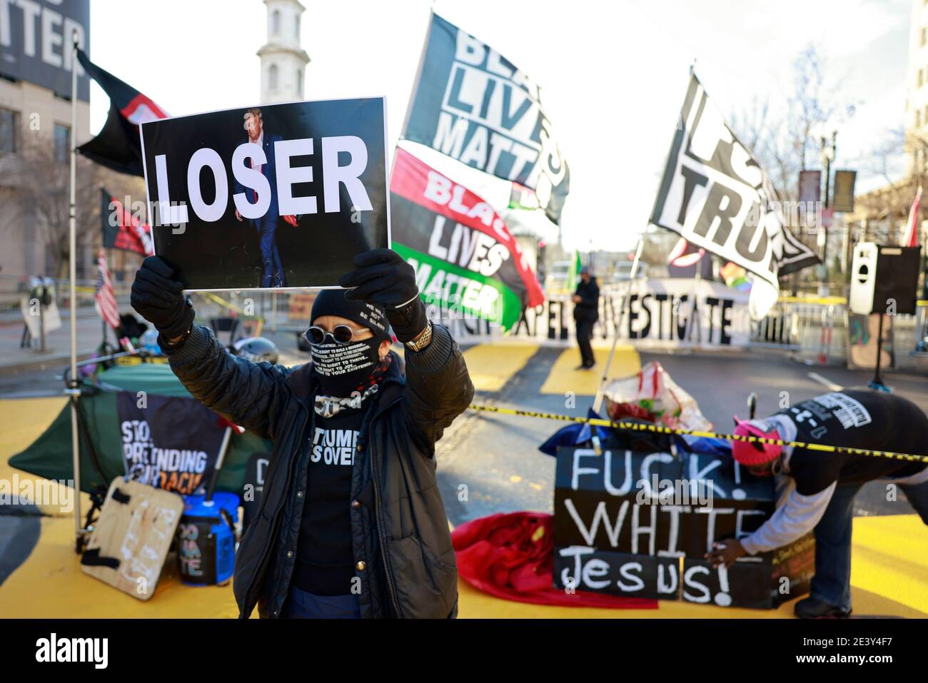 Activist Laurie Arbeiter holds a sign reading 'Loser' at Black Lives Matter Plaza after the departure of Donald J. Trump’s helicopter at the white house on the inauguration day President Joe Biden and Vice President Kamala Harris. Stock Photo