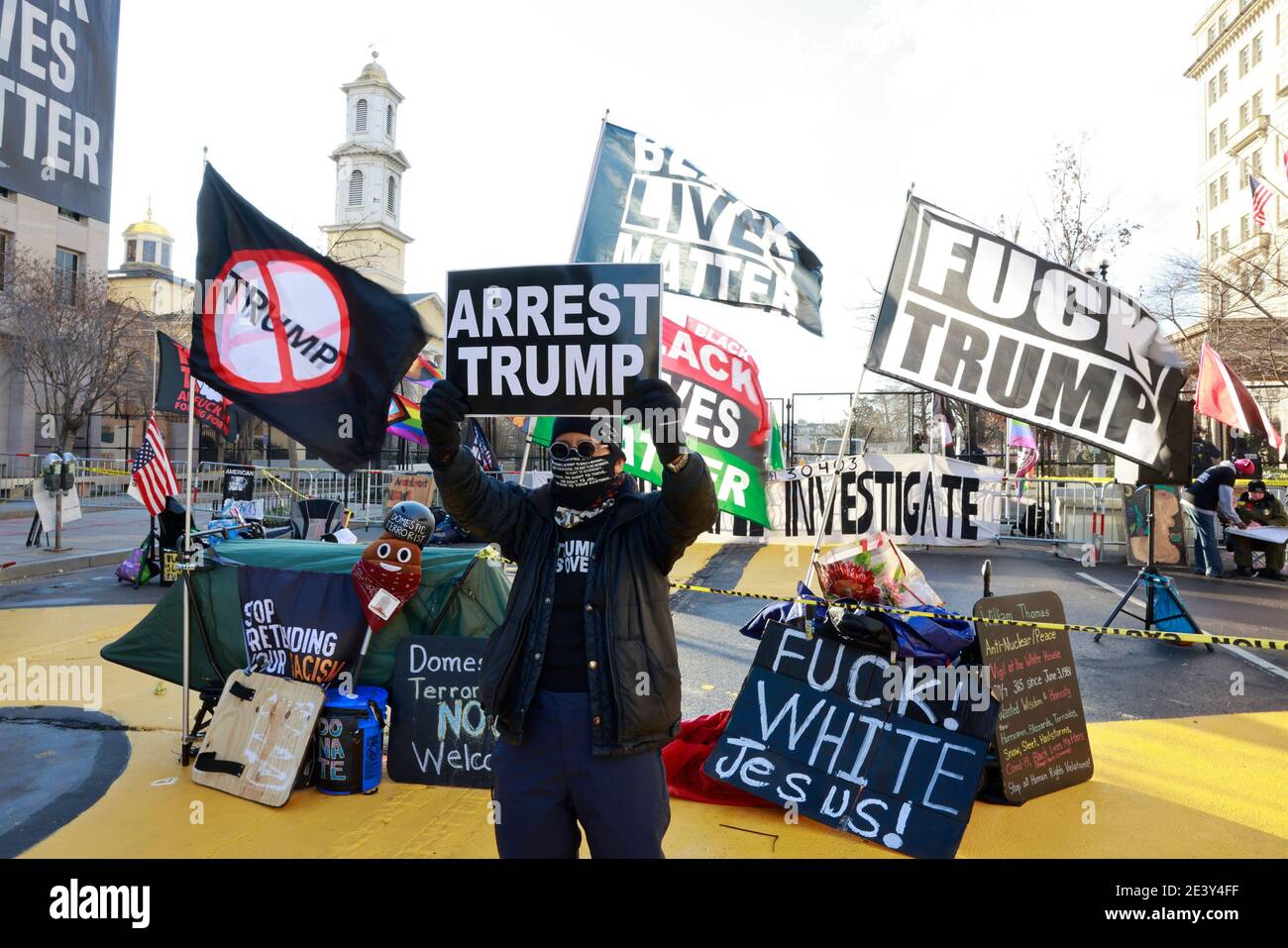 Activist Laurie Arbeiter holds a sign reading 'Arrest Trump' at Black Lives Matter Plaza after the departure of Donald J. Trump’s helicopter at the white house on the inauguration day of President Joe Biden and Vice President Kamala Harris. Stock Photo