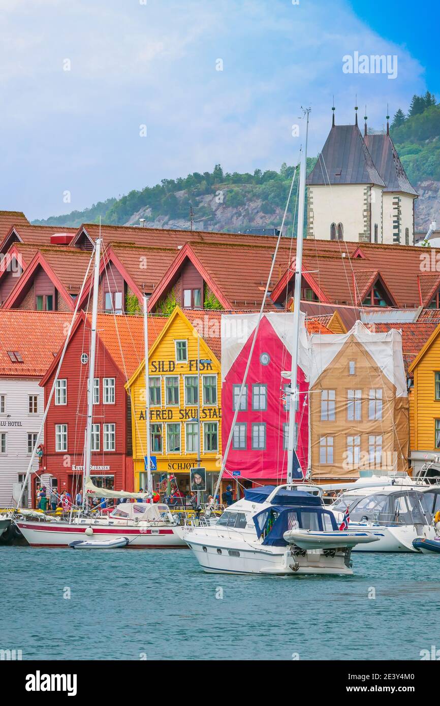 Bergen, Norway - July 30, 2018: City street Bryggen, boats and colorful traditional nordic houses Stock Photo