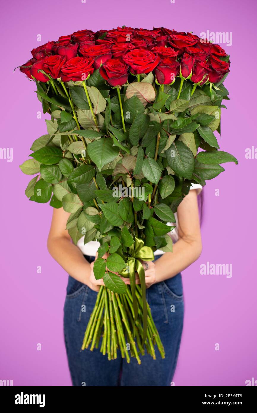 The girl with big bouquet of flowers red roses in front of her Stock ...