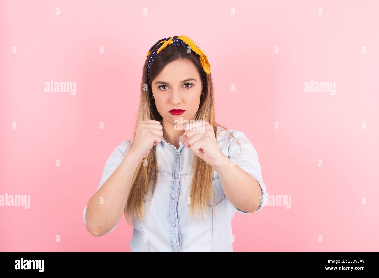 Young woman with her fists ready to fight and defend herself Stock Photo