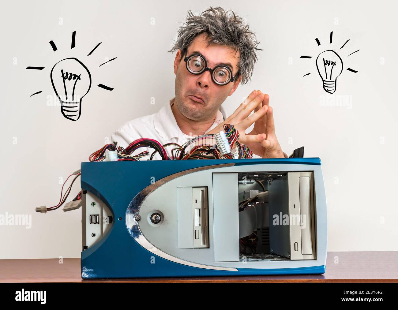 Crazy engineer or scientist repairing computer in laboratory with bulb