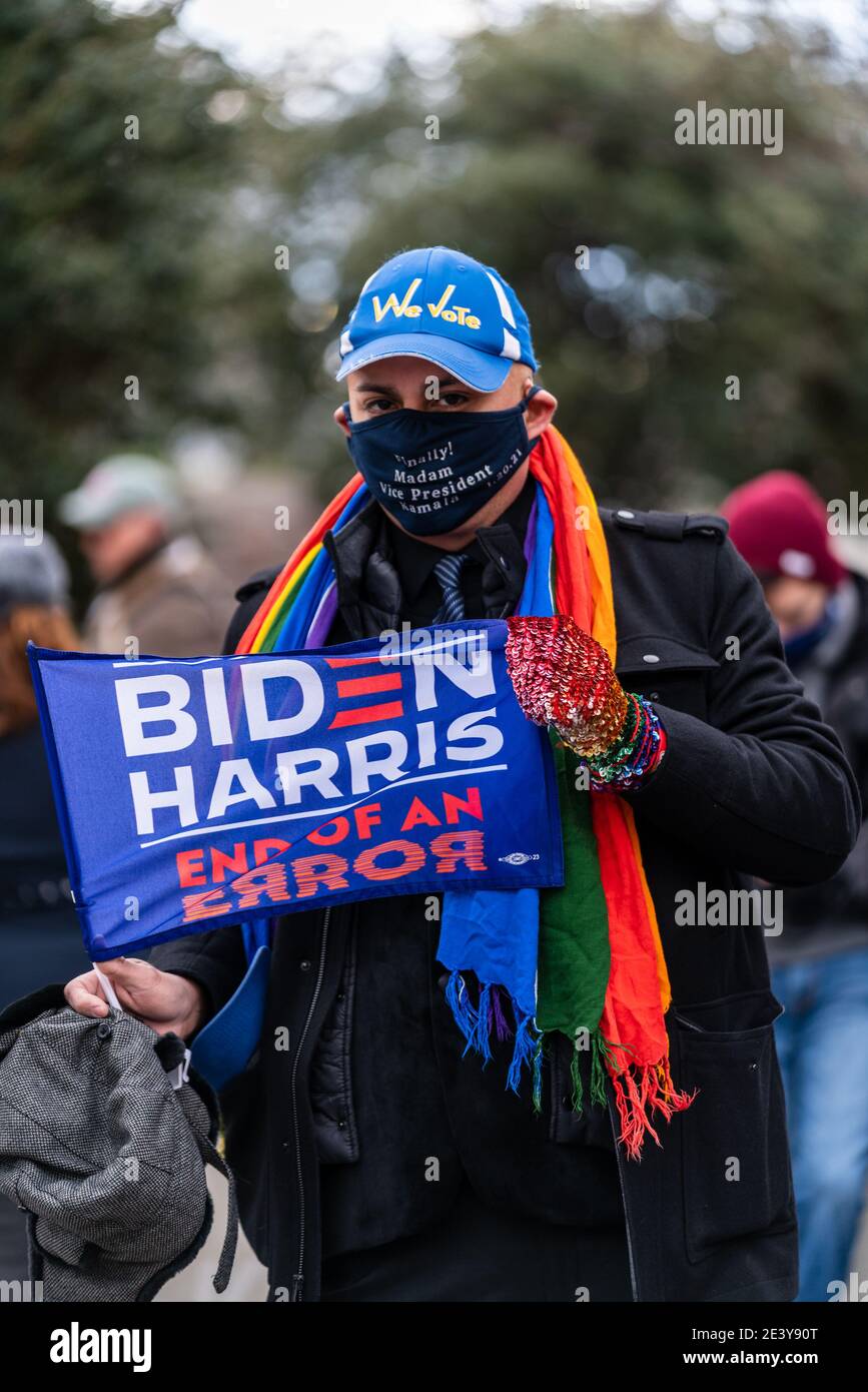A Biden/Harris supporter is holding a sign in front of the Capitol building on the 46th president inauguration day. There were lots of emotions. Stock Photo